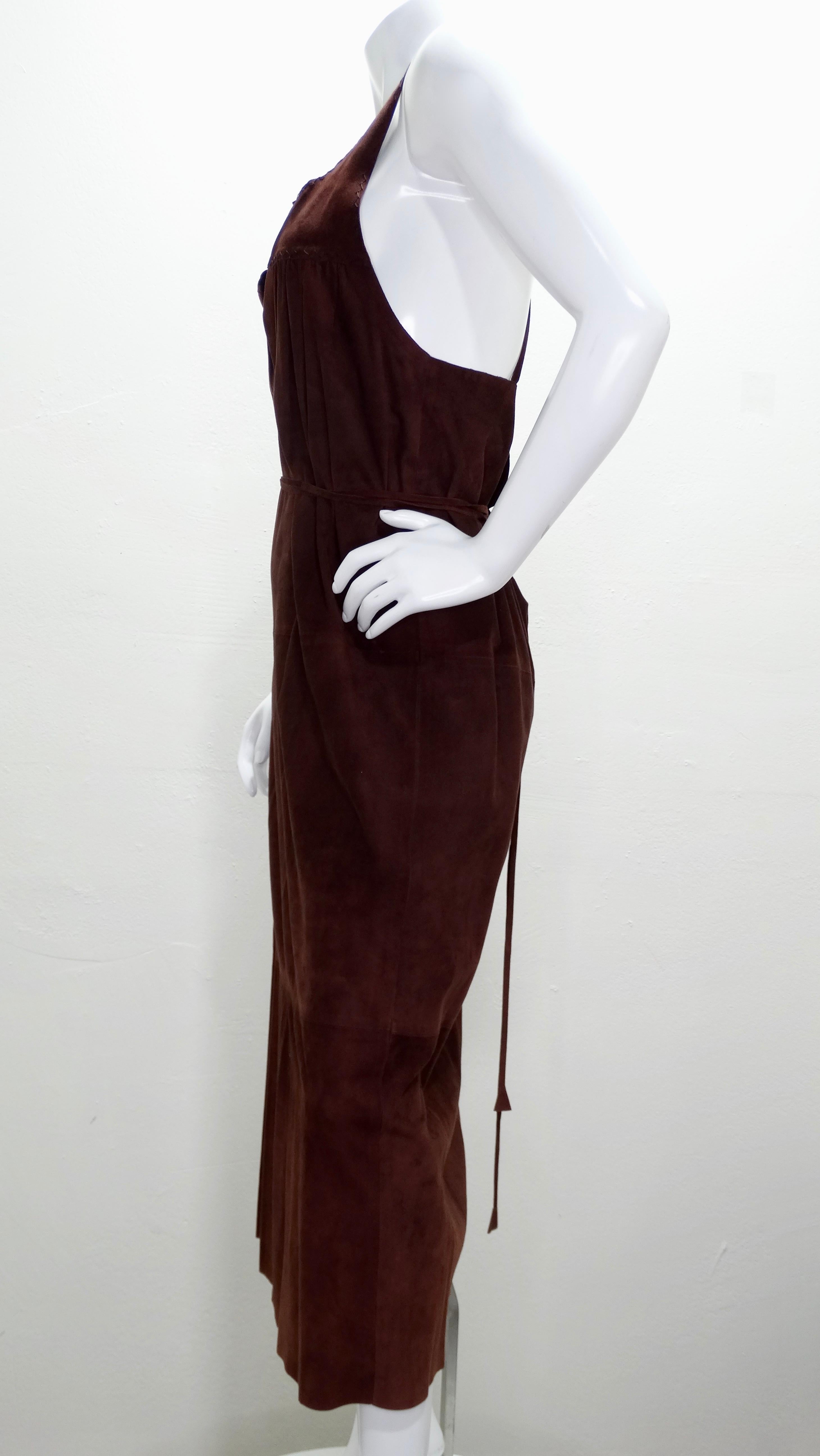 Calling all vintage Gucci lovers! Circa 2002, this chocolate brown suede dress features tank stop straps with a crisscross back, a deep v-neck, exposed stitching trim at the bust, a side slit and an optional suede belt that can also be worn around