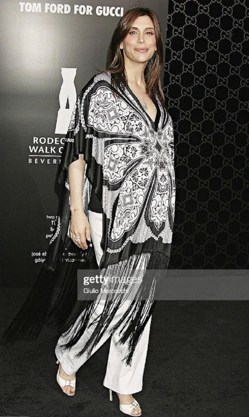 Gucci by Tom Ford Cruise 2003 Black and White Fringe Poncho Top
Step into early 2000s glamour with this striking Gucci poncho, designed by Tom Ford for the Cruise 2003 collection. This rare and iconic piece features an intricate black and white