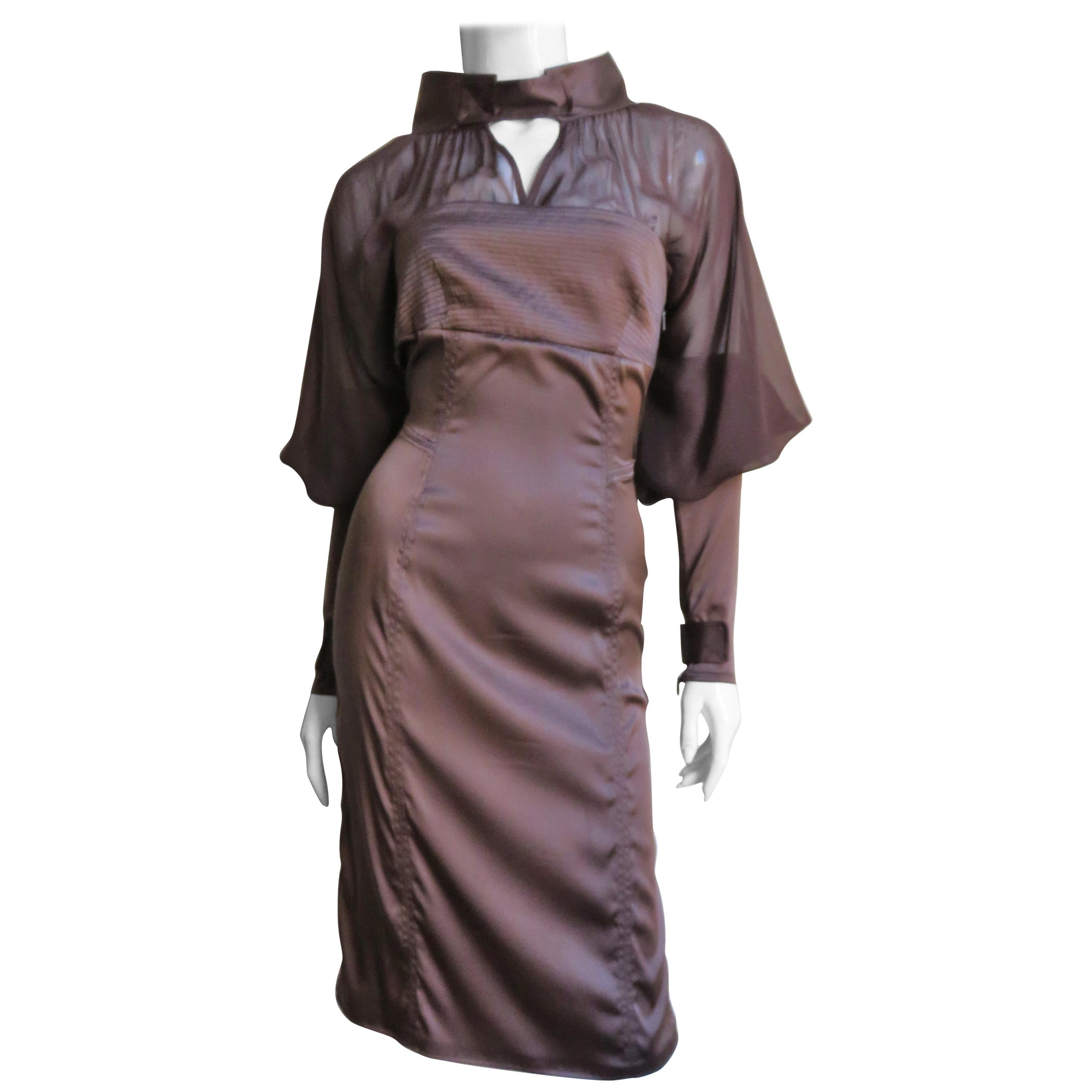 A gorgeous rich brown fine stretch silk dress from Tom Ford for Gucci. The dress portion is strapless then it is sheer to the stand up collar at the neck and to the elbows of the dramatic leg of mutton sleeves which are opaque from elbows to the