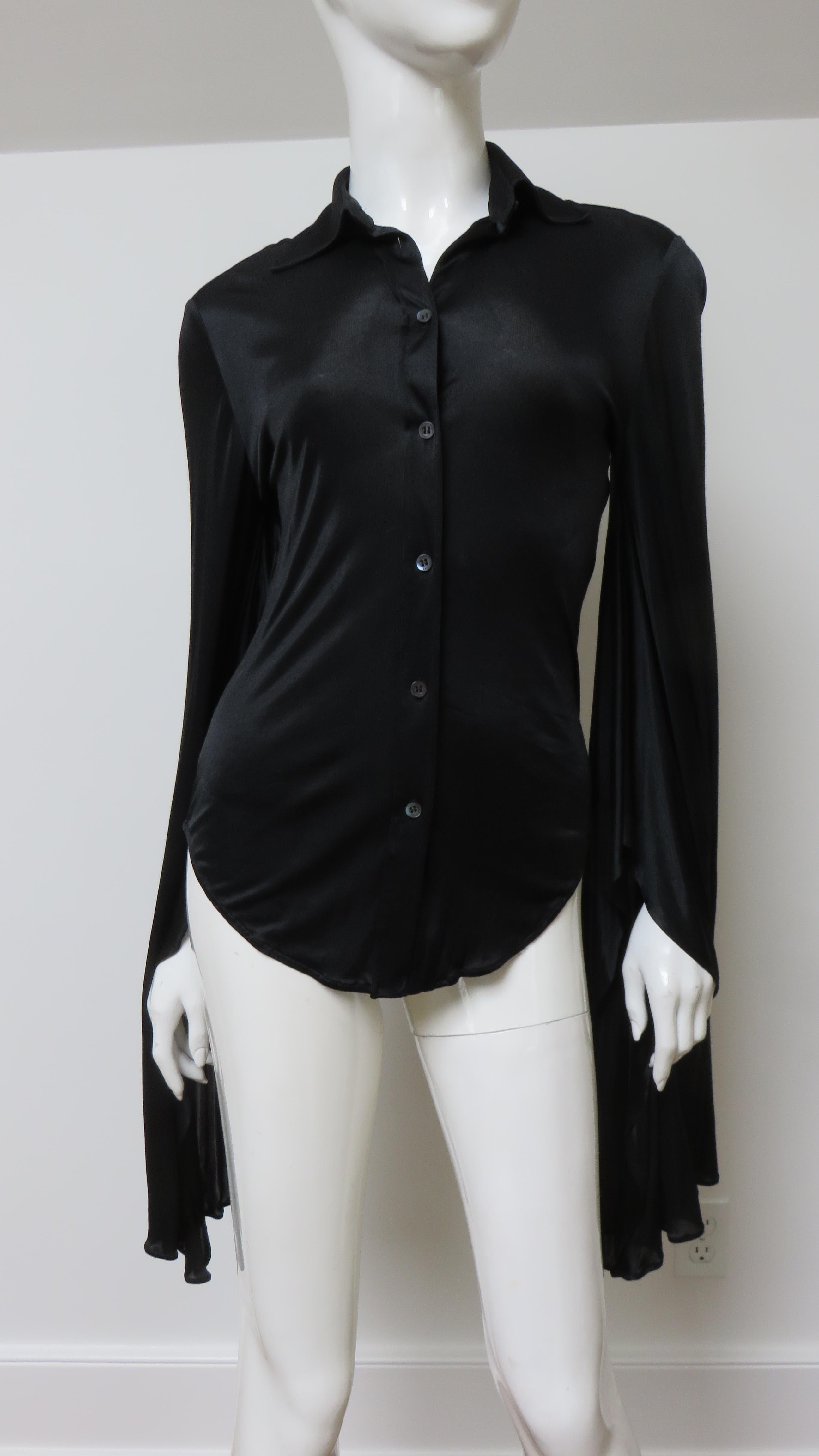 A fabulous black fine stretch silk shirt, top, blouse from Tom Ford for Gucci.  It is semi fitted with a shirt collar, black mother of pearl Gucci inscribed button up the front and great long draping angel sleeves.
Fit sizes Extra Small, Small.