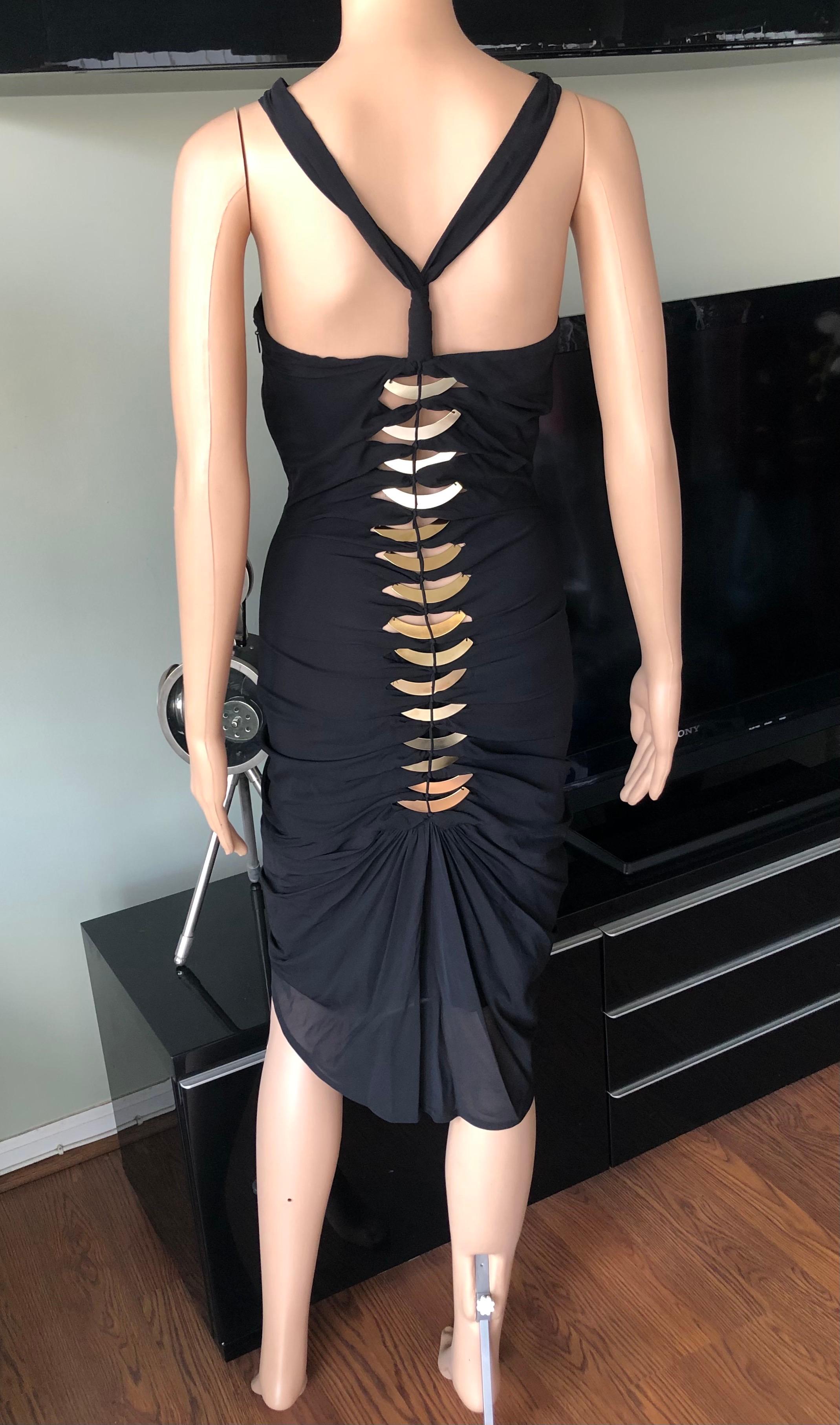 Tom Ford for Gucci c.2004 Embellished Cutout Back Black Mini Dress IT 40

Gucci by Tom Ford black stretchy dress featuring halter neckline, gold metal plates embellishments, cutout accents at back and concealed zip closure at side. 
