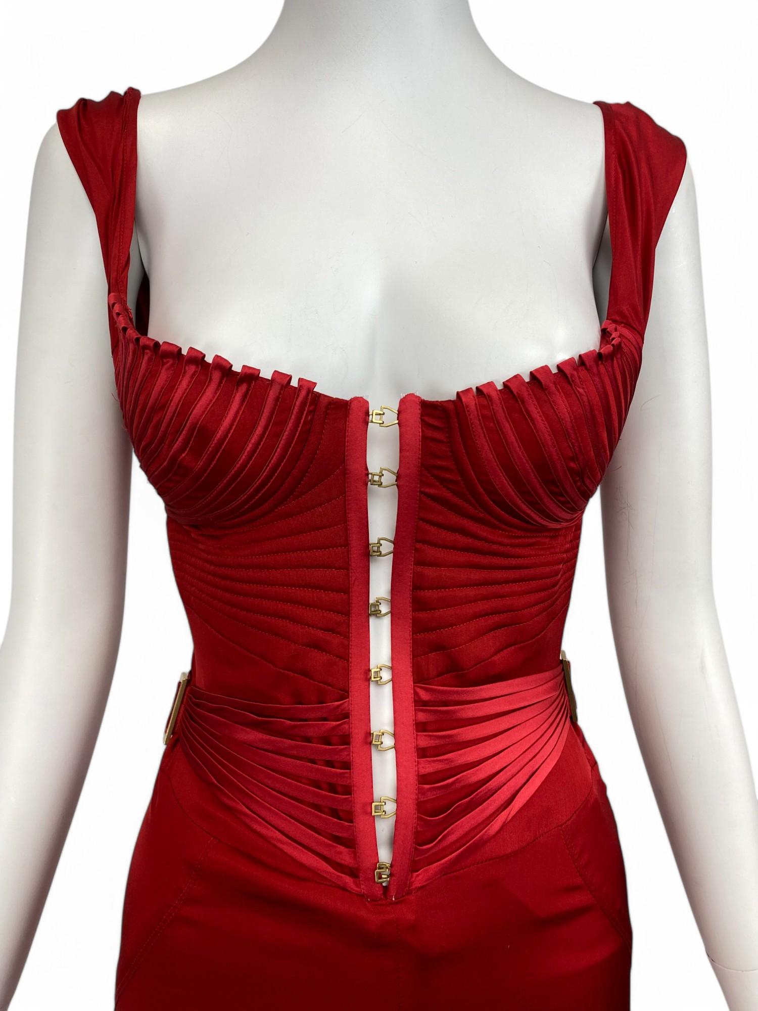 Sensual, sculptural, and undeniably glamorous, this Gucci red silk gown is a showstopping statement of modern femininity. Expertly crafted in fluid silk, the dress features a structured bustier bodice with corset-style boning that cinches the waist