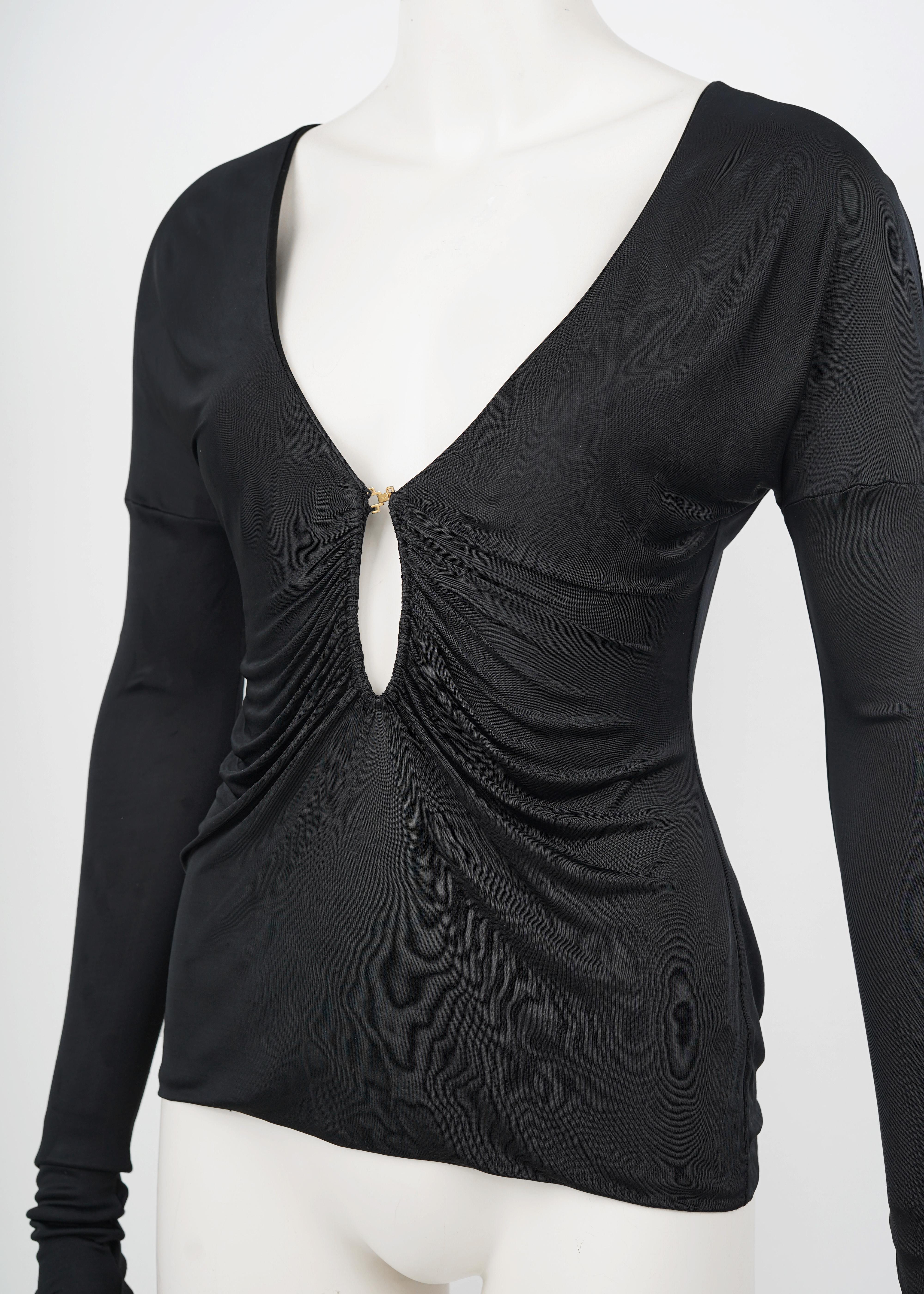 A rare and sultry piece from Tom Ford’s final collections at Gucci, this black draped top from the Fall/Winter 2003 runway epitomizes the designer’s bold, body-conscious aesthetic. Crafted from 100% viscose, the fabric has a fluid, high-sheen finish