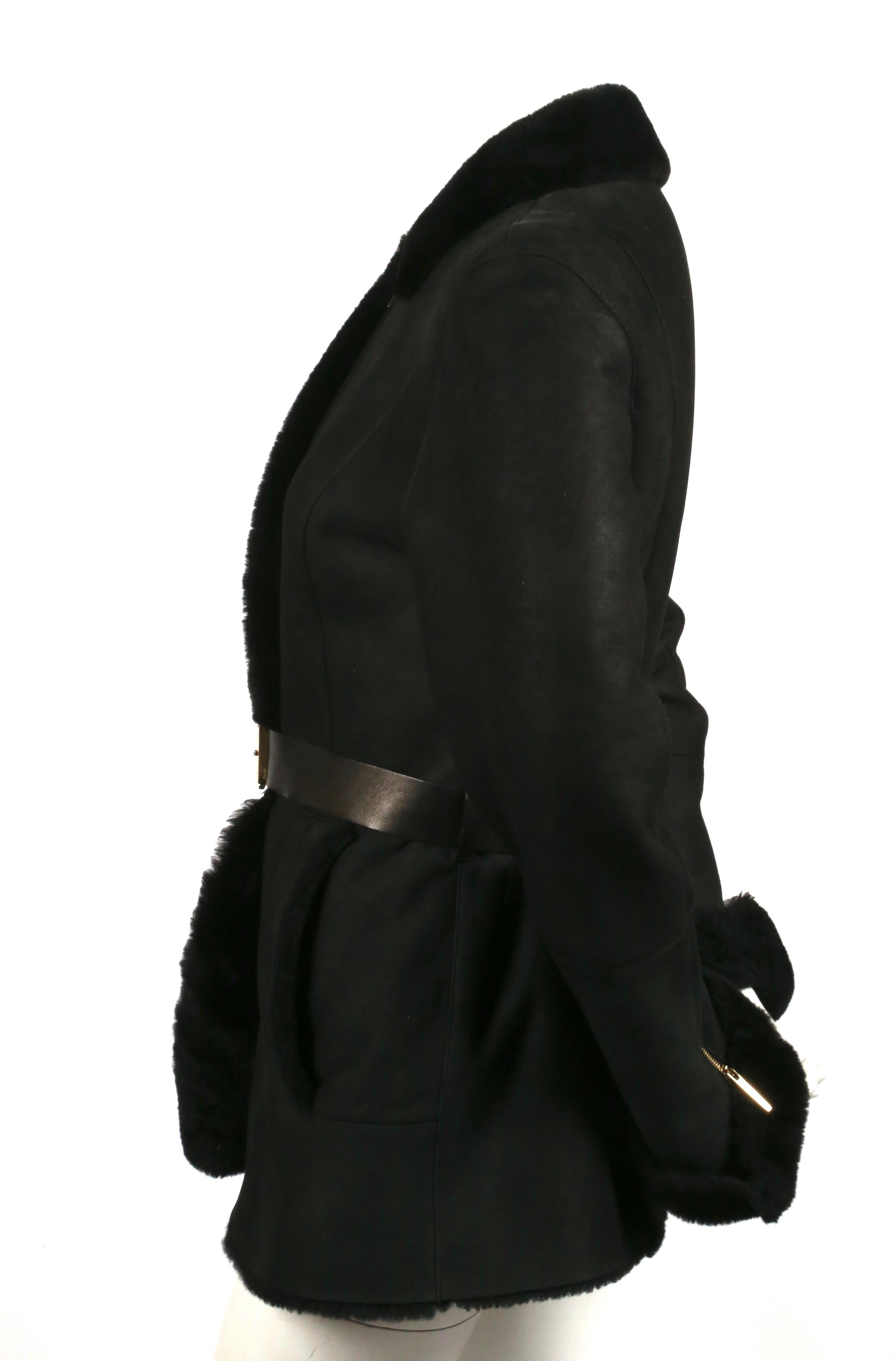Fitted, black shearling coat with leather belt designed by Tom Ford for Gucci dating to the early 2000's. Italian size 42. Approximate measurements: shoulder 17.5
