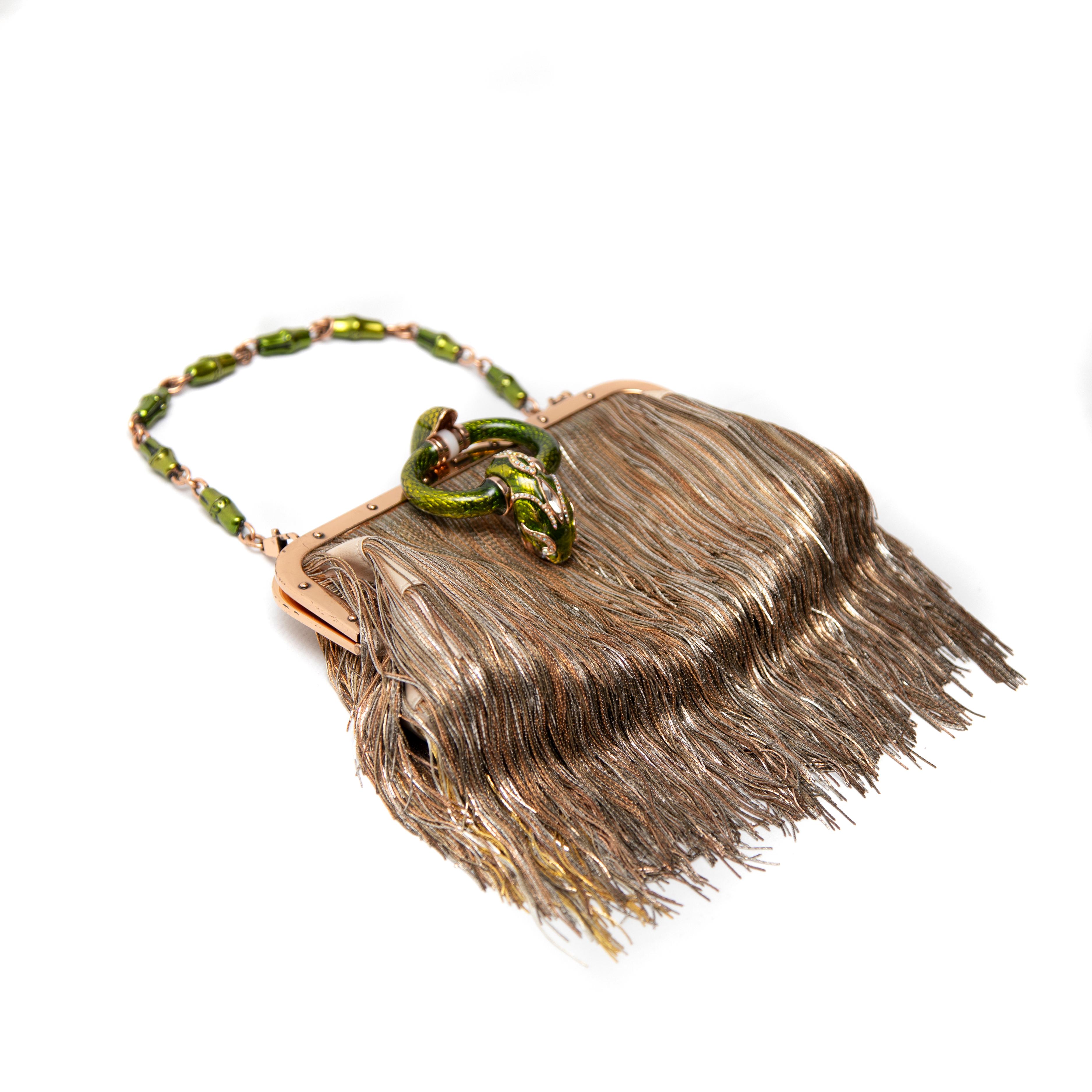Elevate your evening ensemble with the Tom Ford for Gucci Limited Edition Dragon Evening Handbag Clutch, a striking piece from Runway Look 28 of the Spring 2004 collection. This exquisite clutch is designed to make a bold statement, featuring a