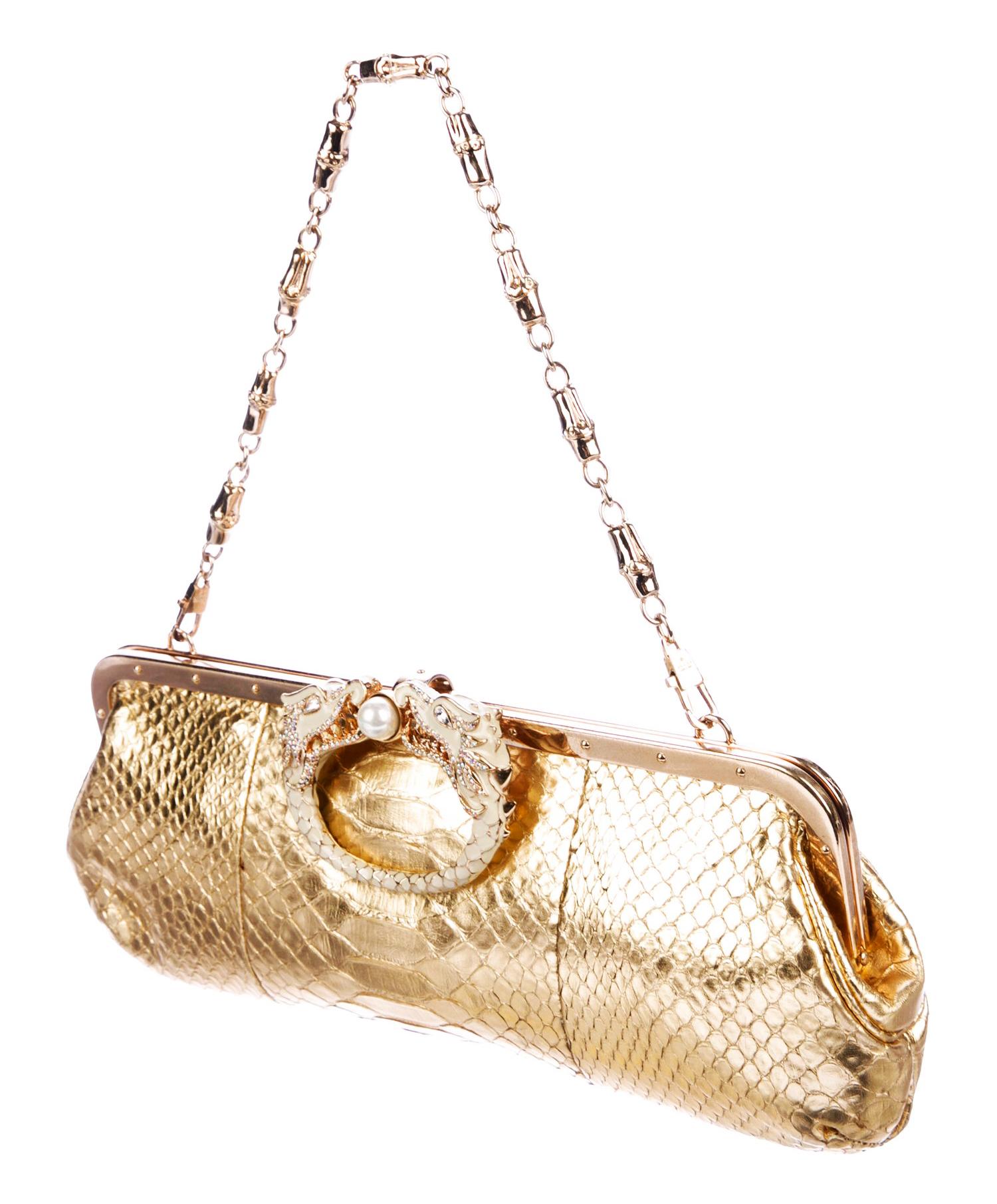Rare Tom Ford for Gucci Limited Edition Gold Python Bag Clutch
F/W 2004 Collection
Made of Exotic Gold Colored Python with Large Detailed Enamel Handcrafted Jeweled Dragon Heads.  A Truly Luxurious and Elegant Piece.
Gold-tone Hardware, Detachable