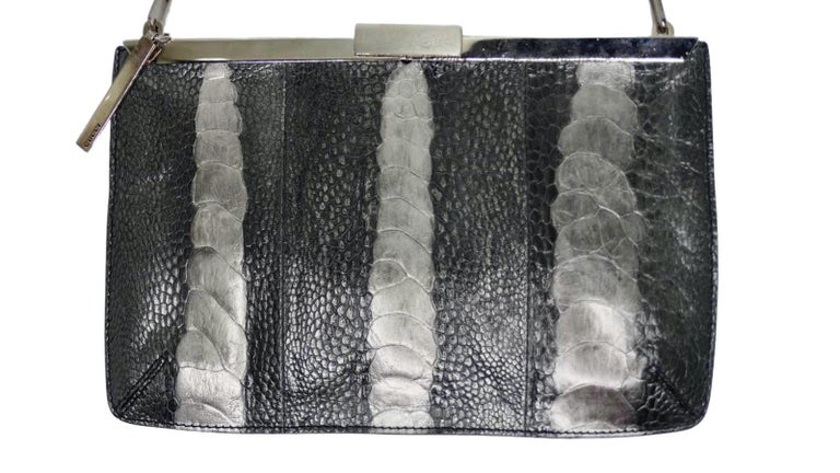 Add this rare piece to your collection! Designed by Tom Ford for Gucci's 2000 S/S show, this evening clutch is crafted from ostrich leg leather and features a two-tone silver metallic finish, silver hardware, chain link shoulder strap and a flip tab