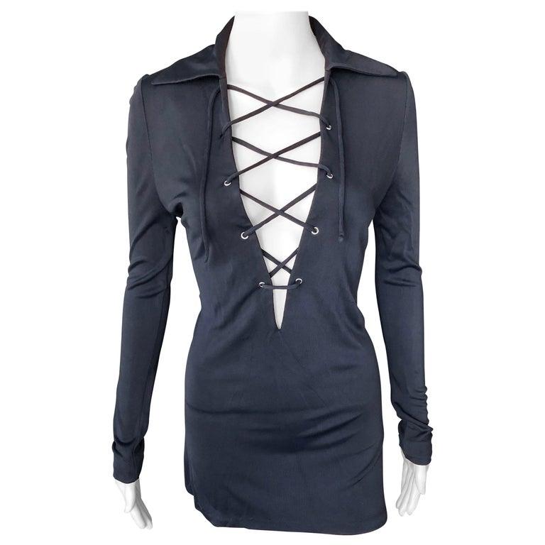 Tom Ford for Gucci S/S 1996 Plunging Lace-Up Black Tunic Micro Mini Dress IT 44

Gucci knit dress featuring plunging neckline, pointed collar, long sleeves and lace-up closures at front. 

