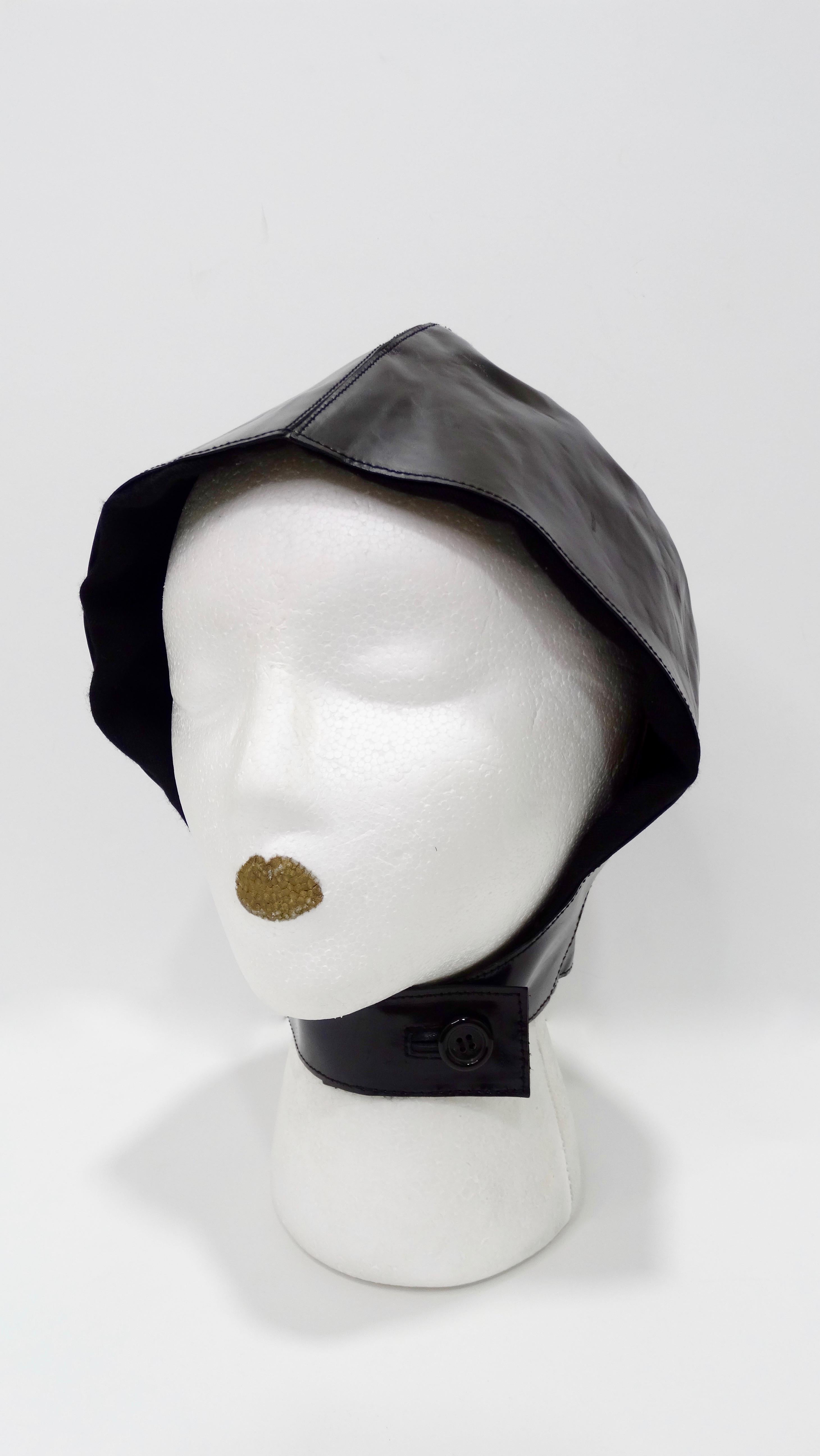 Straight from the Tom Ford archives! Circa 2003 from YSL's S/S collection, this flight cap is crafted from a shiny smooth black patient leather and is lined with cashmere and silk. Features a neckband that can be securely buttoned. Unique and a true