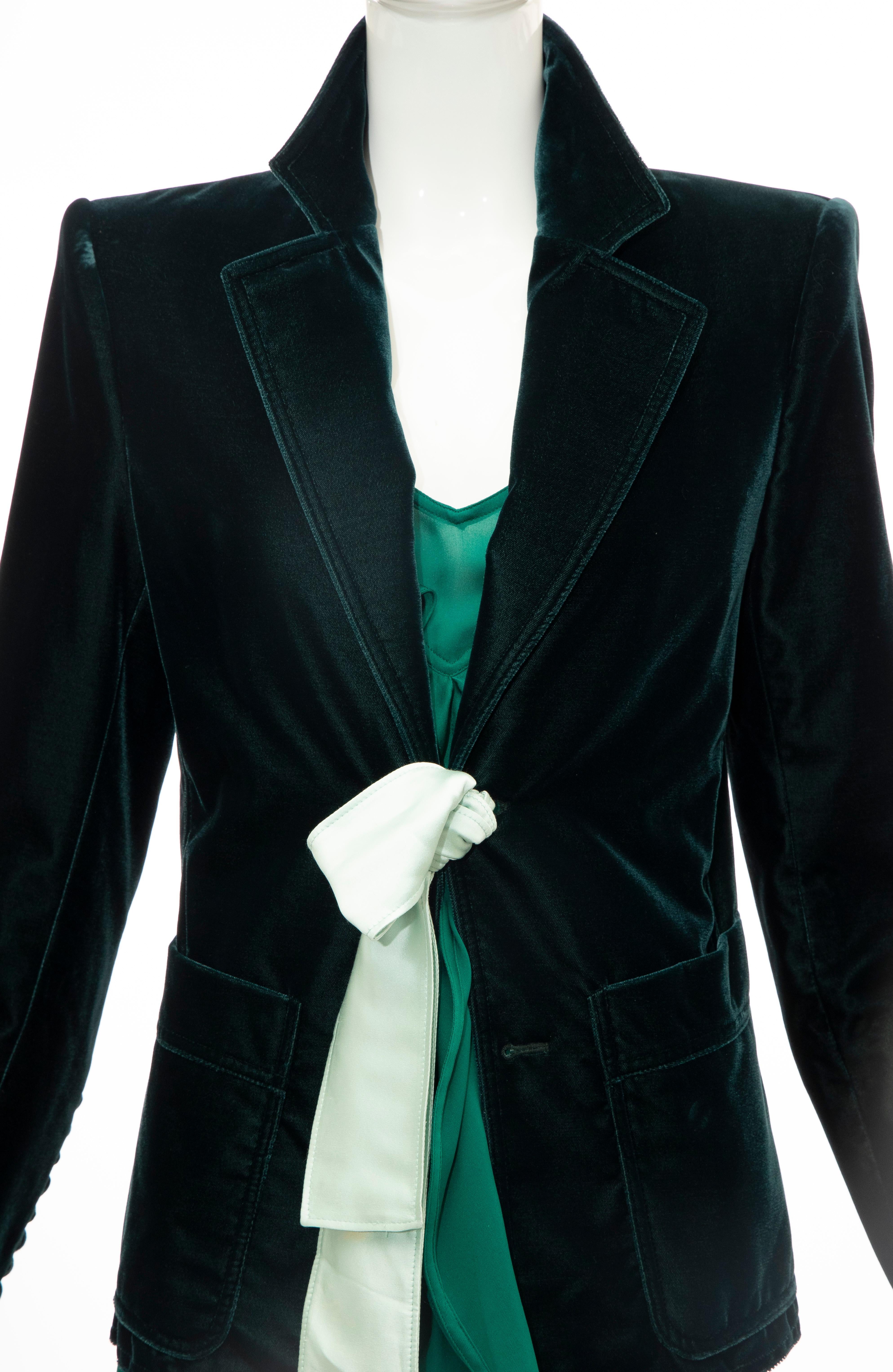 Tom Ford for Yves Saint Laurent, Fall 2003 emerald green velvet & silk dress suit. Emerald green velvet blazer has notch-lapels with structured shoulders, dual patch pockets at waist and satin tie closure at center front. The emerald silk sleeveless