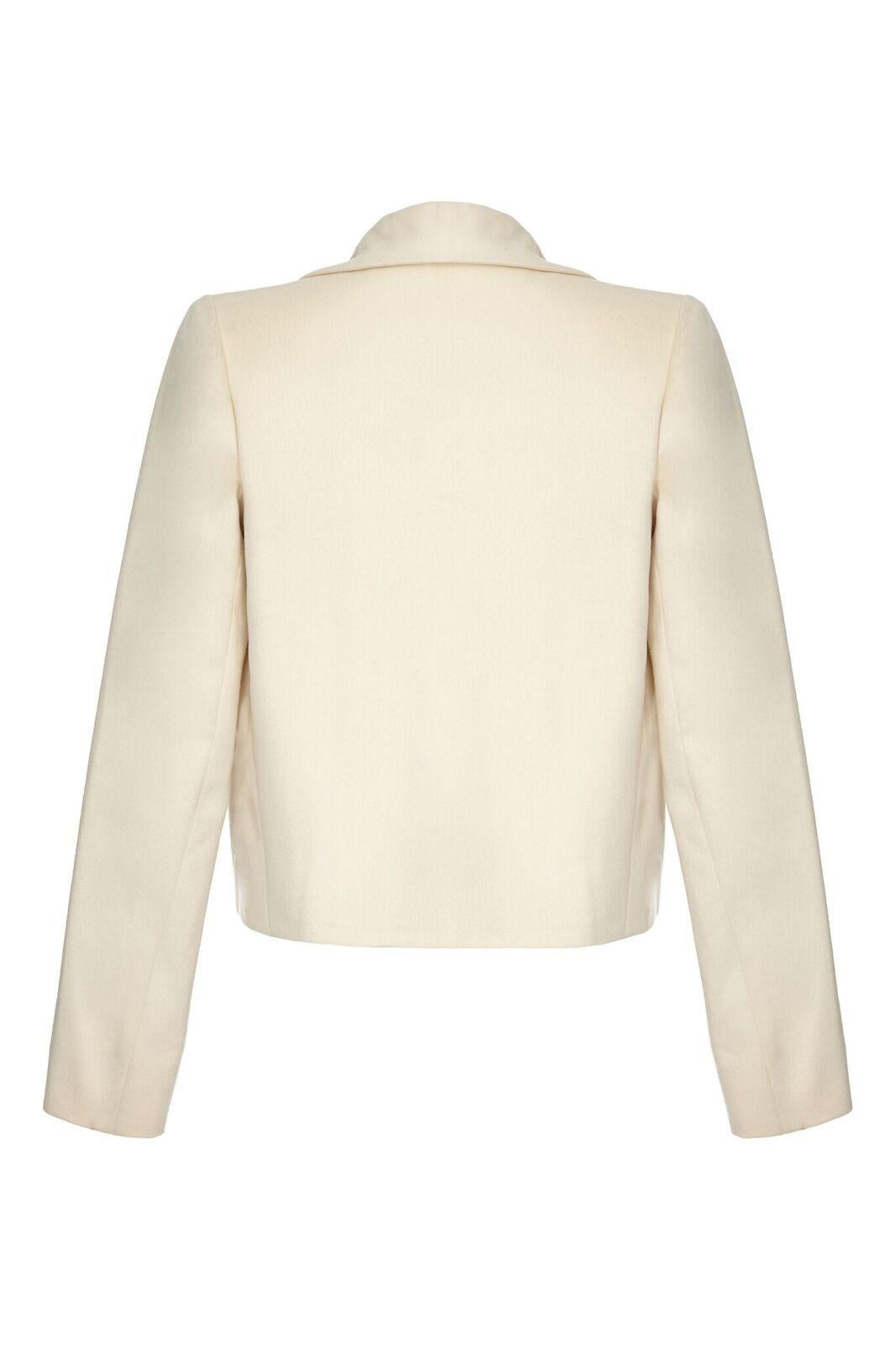 This stylish cashmere structured jacket in warm ivory is by Tom Ford for Yves Saint Laurent circa 1999. Designed to be worn open, the jacket has a wide set, New Look style wing lapel which graduates seamlessly into the centre line to create a deep