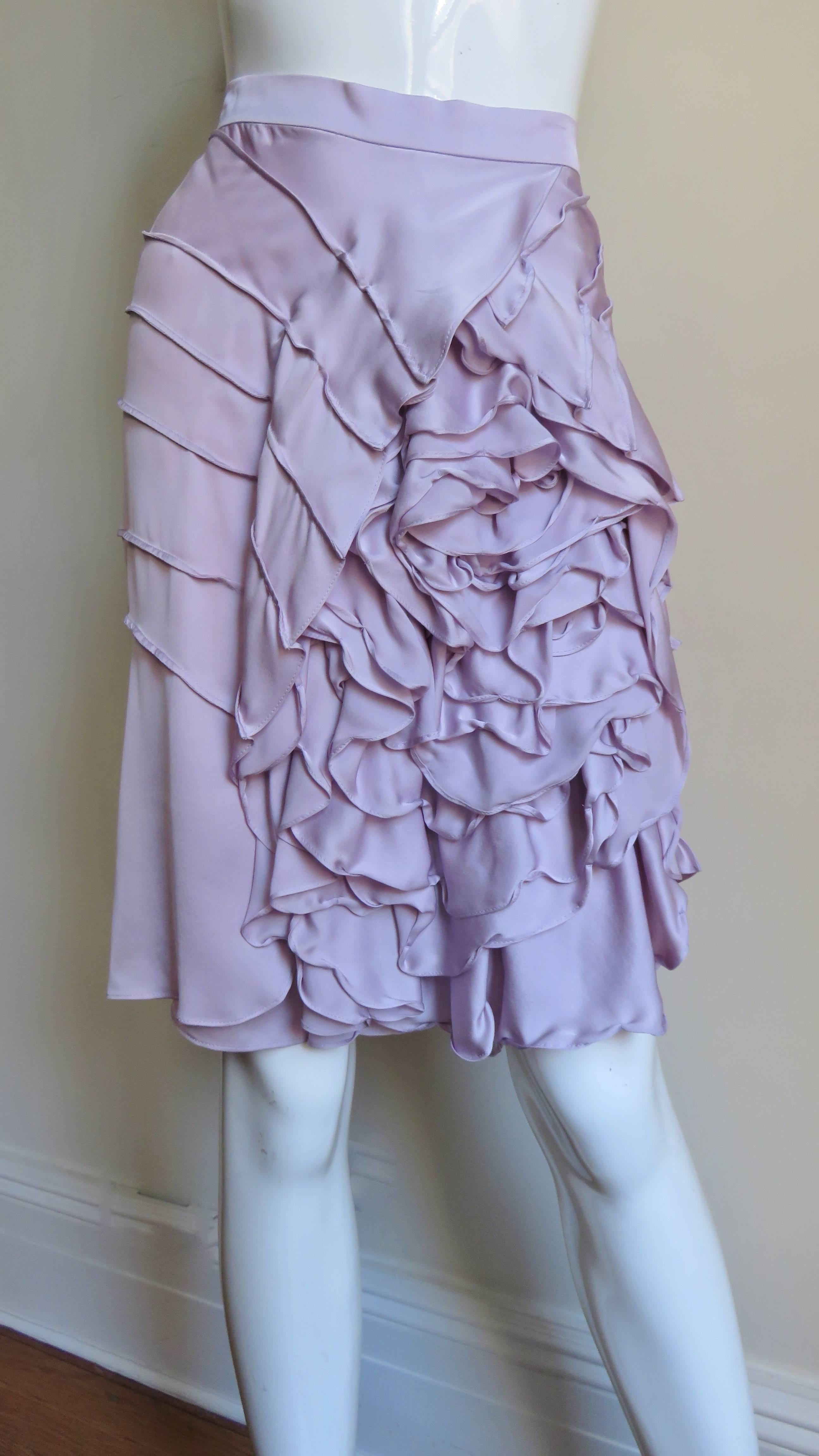 A gorgeous lavender silk skirt by Tom Ford for Yves St Laurent, YSL S/S 2003 Collection.  A large intricately detailed ruffle draped flower adorns most of the front skirt with a series of seams emanating from it wrapping around to the back .  It has