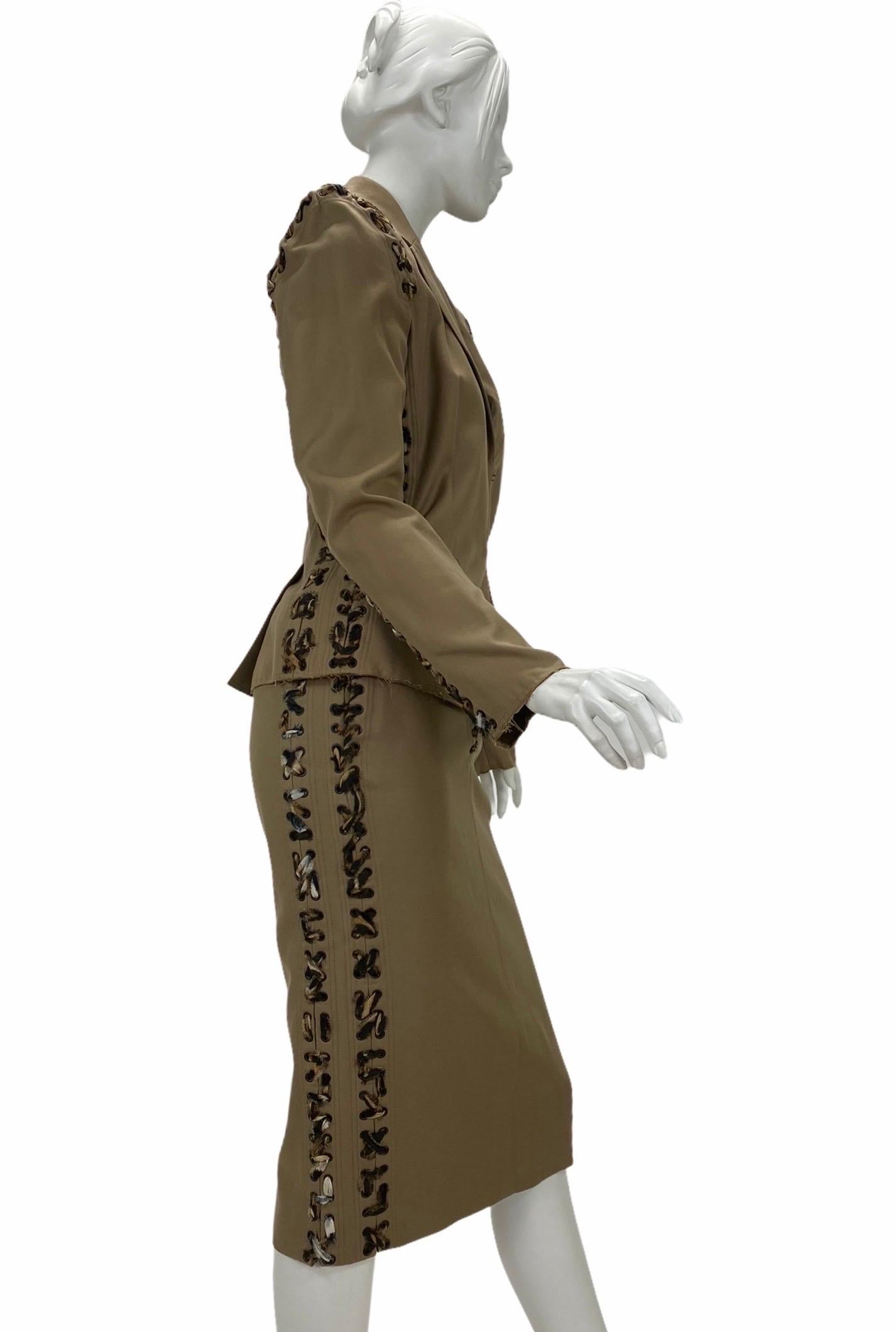 Tom Ford for Yves Saint Laurent Safari Skirt Suit
S/S 2002 Runway Collection
Fr. Size 36 - US 4
The tailored jacket is made of khaki cotton and features a sharp cut with sculpted, padded shoulders, front pockets, raw edges, a hook and eye closure at