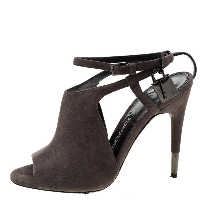 These stunning Tom Ford peep-toe sandals are a perfect pair to wear for both day and night time occasions. Constructed in grey suede, these shoes feature ankle straps that come accented with a textured lock and a key that won’t go unnoticed. The