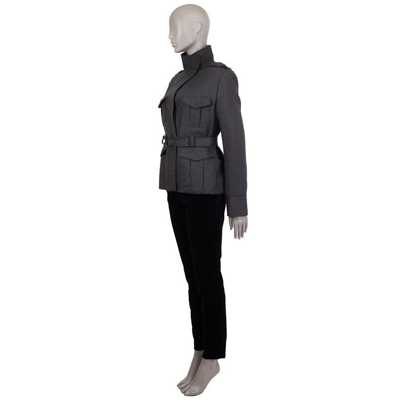 Tom Ford 'Tricotine' belted jacket in charcoal wool (99%) and cashmere (1%) with a flap collar and two decorative shoulder straps. Closes on the front with buttons and comes with a matching belt. Has two large deep pockets on the front and two chest