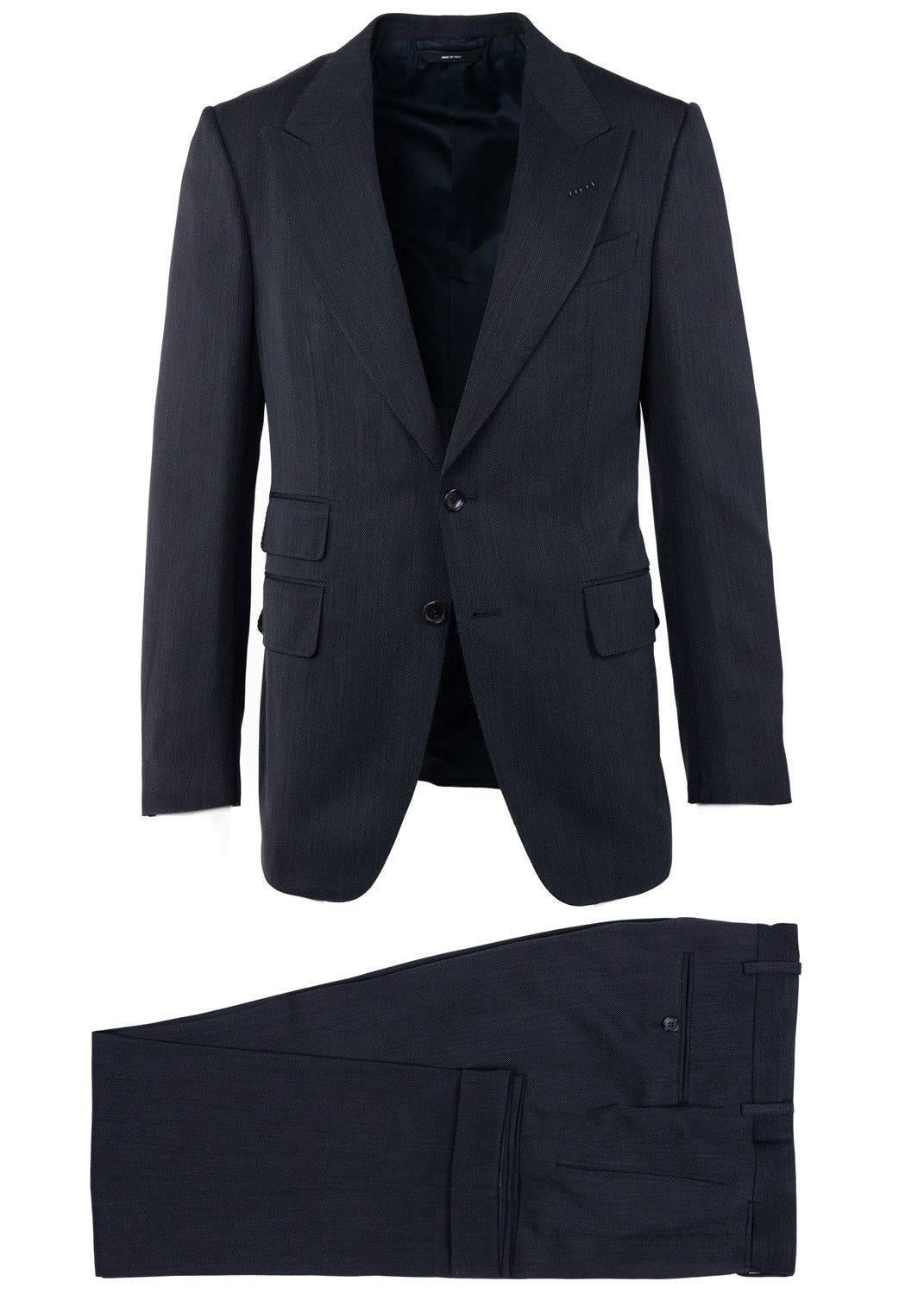 The best way to seal the deal is in your Tom Ford Shelton Suit. This impeccable two piece features a subtle micro stripe texture, peaked lapels, and dark grey marbled buttons. You can pair this suit with a crisp button down for minimalist