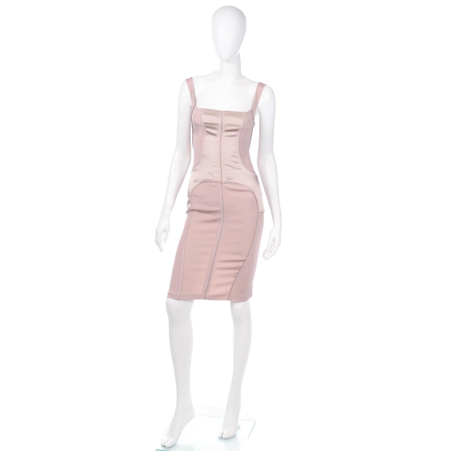 This sensational 2003 Gucci bodycon silk blend dress was designed by Tom Ford and we love the silhouette! The matte and satin mauve nude dress closes with a side zipper and has decorative top stitching and trim with a corset style fit We estimate