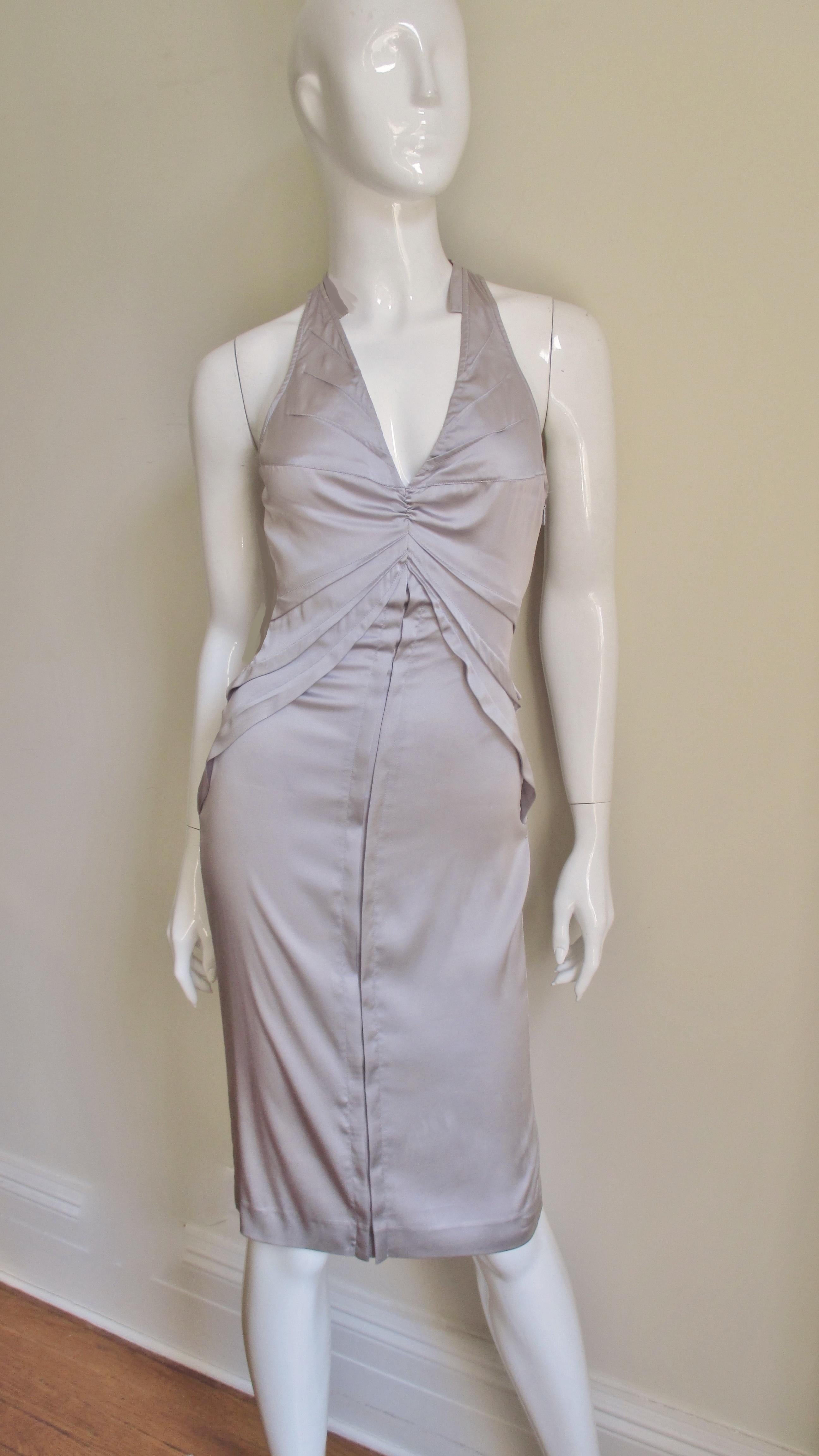 A fabulous lavender stretch silk dress by Tom Ford for Gucci S/S 2003 collection.  It has a plunging front neckline and racer back with multiple seams emanating from it and the side seams drawing in the waist.  It has a straight skirt with a slit at