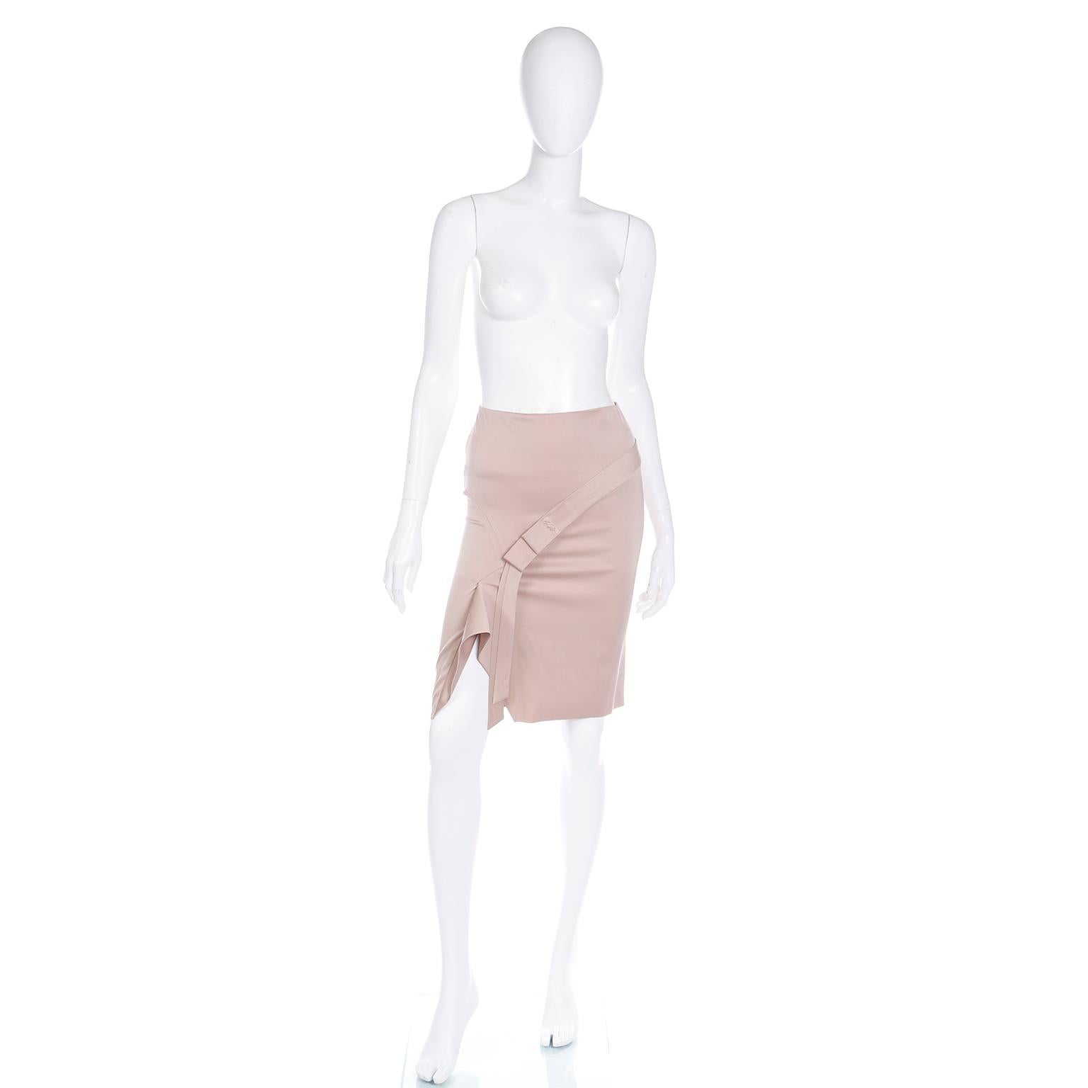 This incredible ultra modern looking Tom Ford for Gucci 2000s skirt is made of a luxurious silk blend in a pale gold with pink undertones.The skirt has a slim fit and an interesting bow detail. Its asymmetrical design is both classic and on trend,