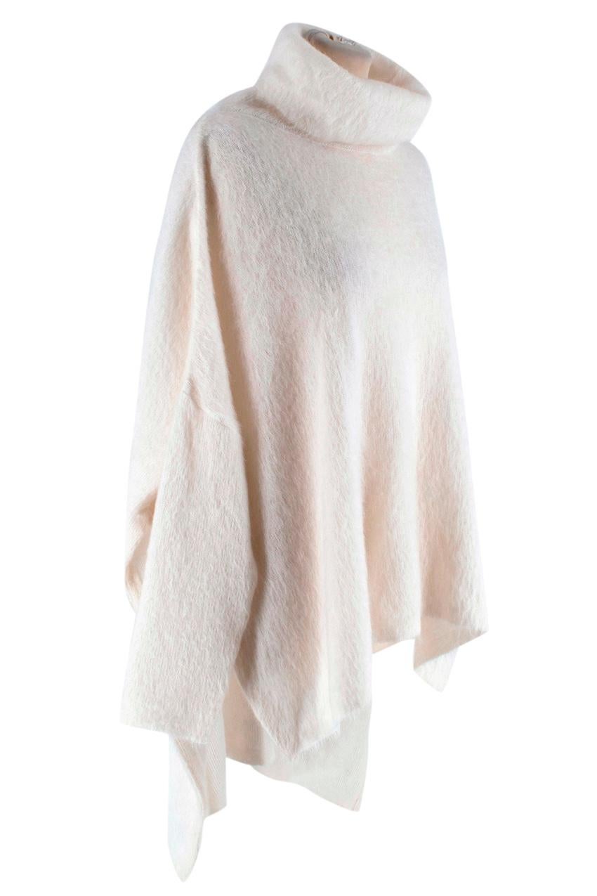 Tom Ford Ivory Mohair blend High Neck Knit Sweater

-Amazing luxurious soft mohair texture 
-Oversized, drop shoulder design
-Neutral Ivory color for easy styling  
-Classic timeless design 
-High neck  
-High low style  
-Side slits 
-Perfect for a