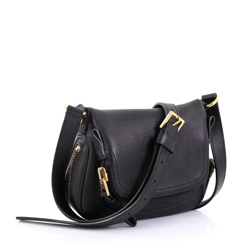 This Tom Ford Jennifer Crossbody Bag Leather Mini, crafted in black leather, features an adjustable crossbody strap, zip-top fold-over flap, and gold-toned hardware. Its zip closure opens to a black microfiber interior with side zip