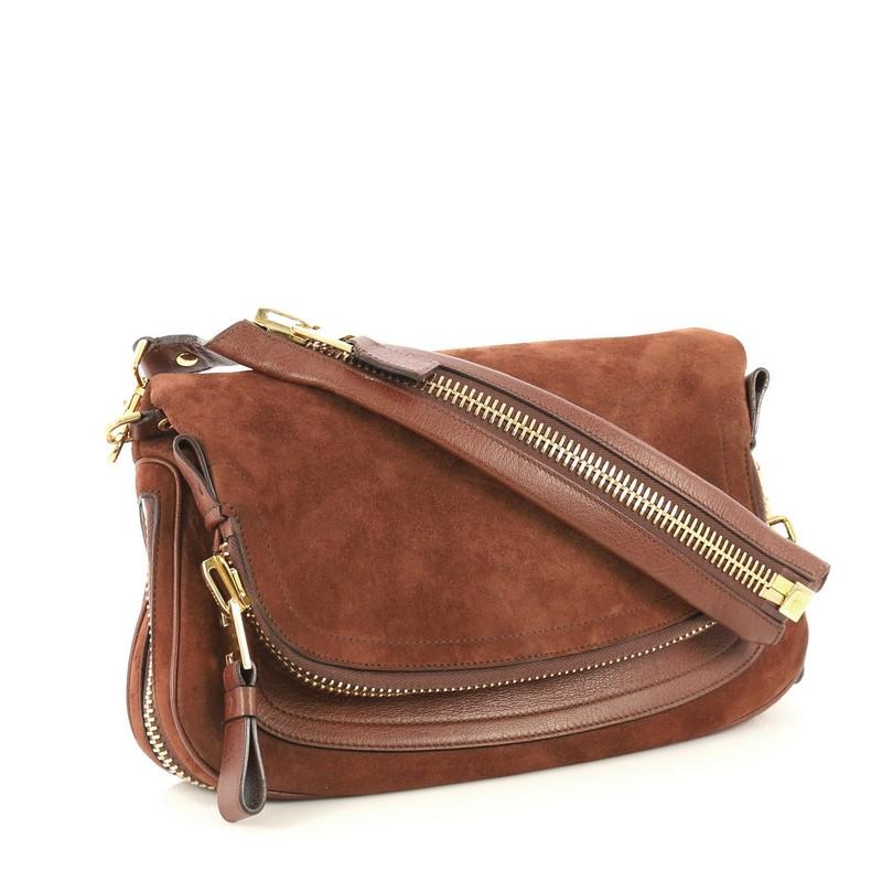 This Tom Ford Jennifer Shoulder Bag Suede with Leather Medium, crafted in brown suede with leather, features an adjustable shoulder strap, zip top fold-over flap, expandable zip sides, and gold-tone hardware. Its zip pocket and fold-over flap