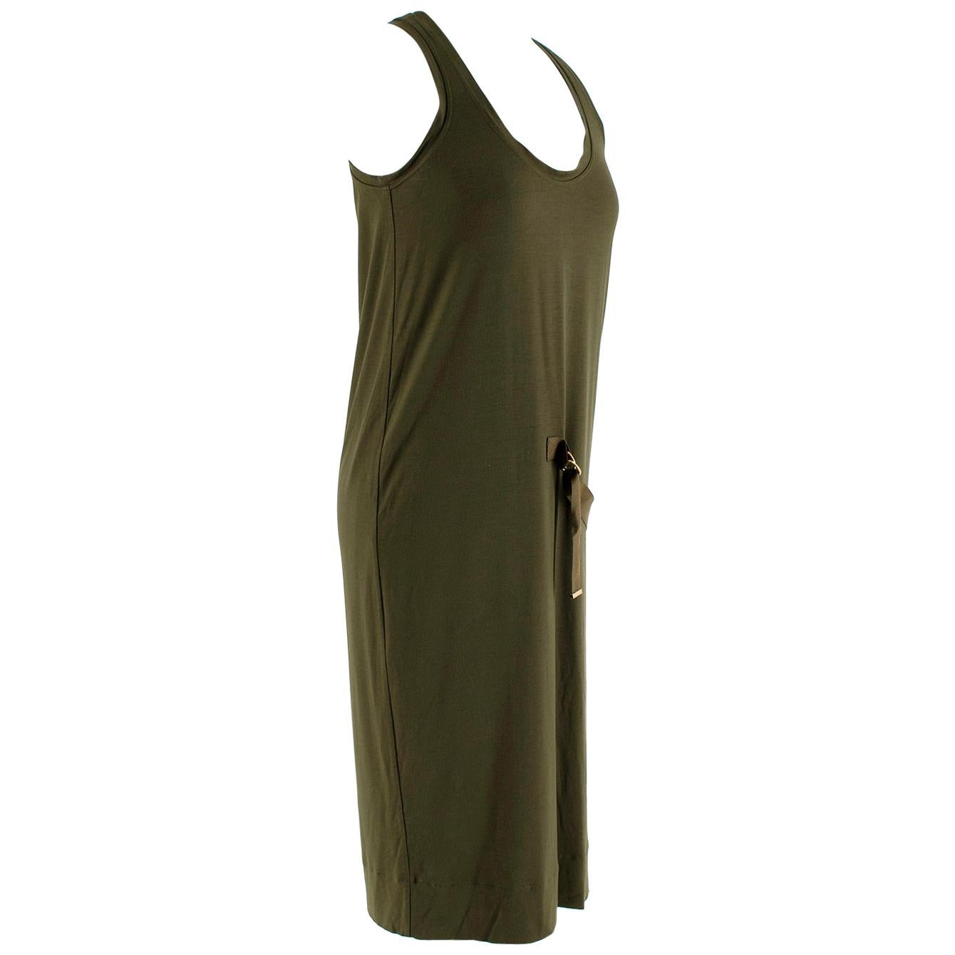Tom Ford Khaki D-Ring Detail Shift Dress 

- Sleeveless With A Scoop Neckline 
- Heavyweight And Loose Fitting 
- Khaki Fabric Adjustable D-Buckle Detail 
- Gold Hardware 
- Pull-over
- Mid Length 

Material:
- 95% Viscose 
- 5% Elastane 

Made in