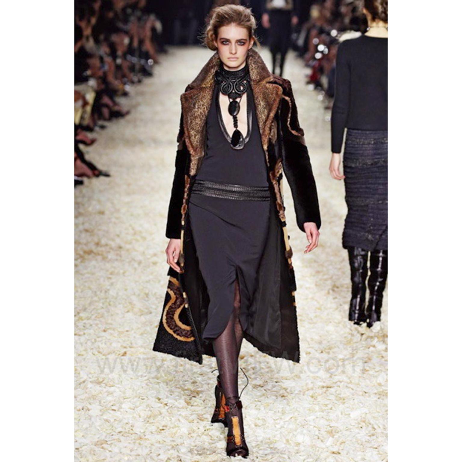We love this Tom Ford F/W 2015 dress! The dress was featured on the runway and is so unique with its incredible leather details. The bodycon dress has a braided leather band collar around the neck that continues throughout the bust. There is a very