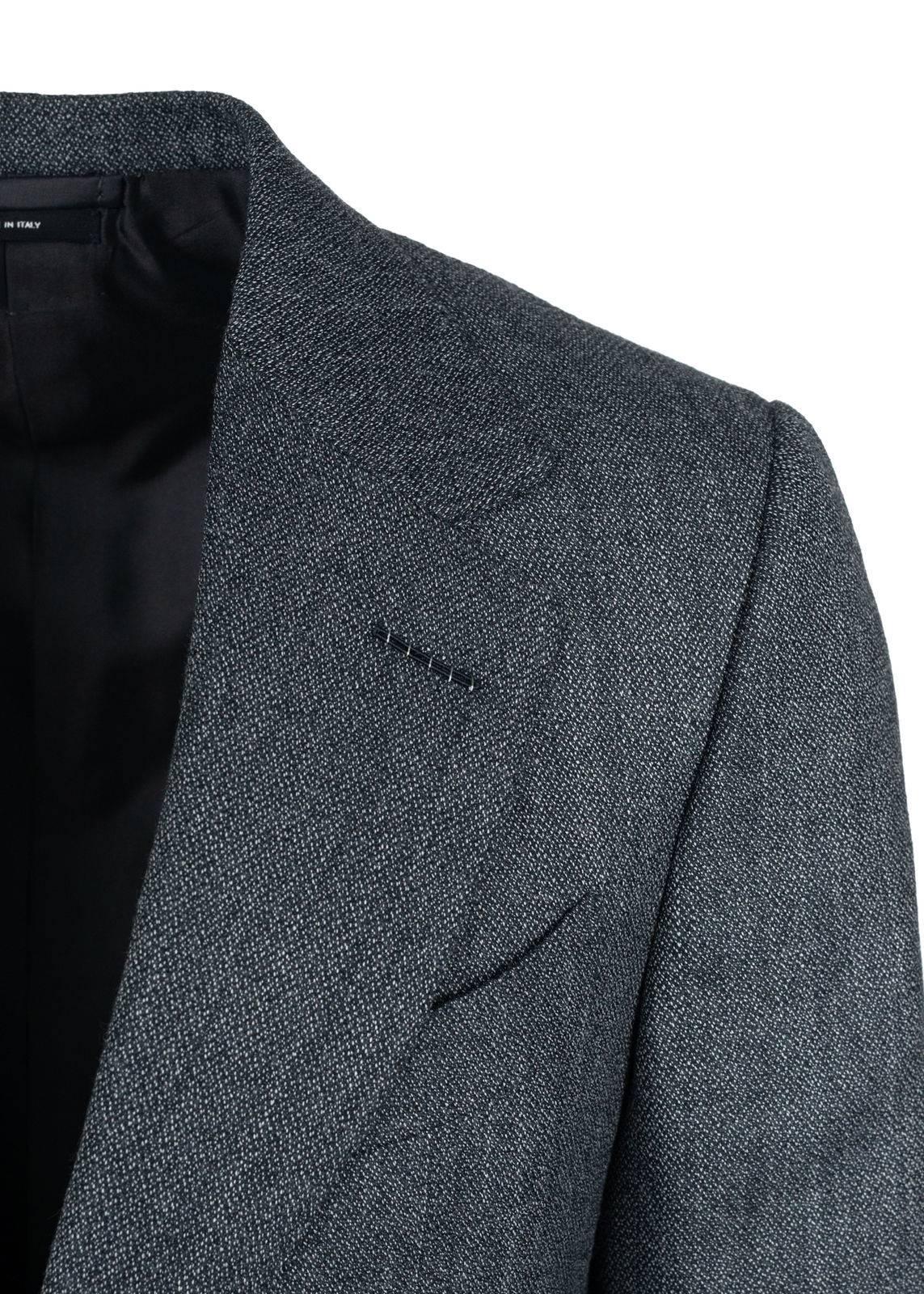 Tom Ford adds an elegant twist to his classic silhouette suit. Crafted of high quality blend of wool and silk this mouline suit features an salt and pepper pattern with a center vent, wide peak lapel jacket and tapered pleated front trousers. This
