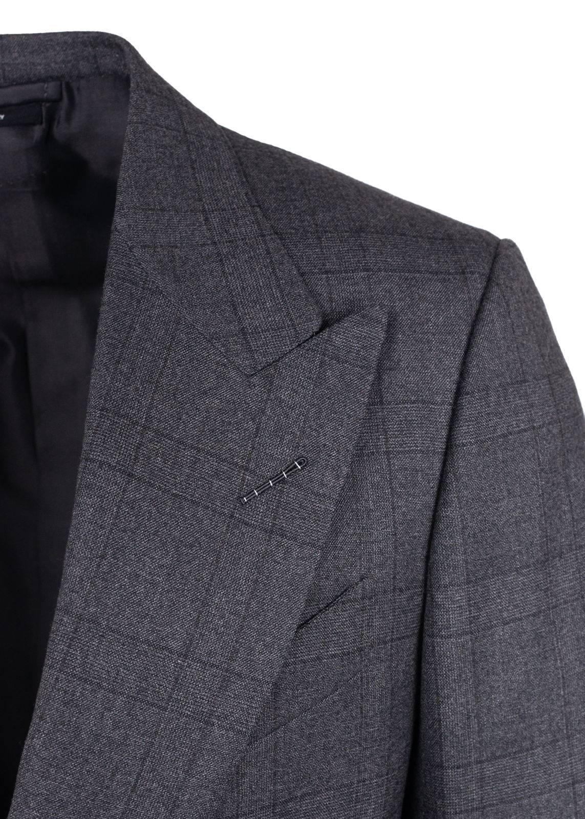 Tom Ford adds an elegant twist to his classic silhouette suit. Crafted of high quality pure wool this suit features an all over grey tone check pattern with a center vent, wide peak lapel jacket and tapered pleated front trousers. This suit lends