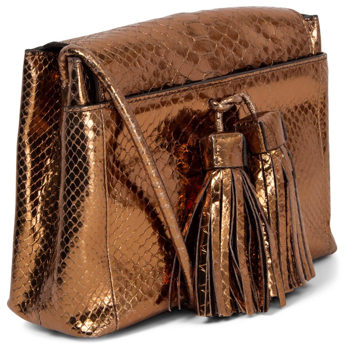 100% authentic Tom Ford Envelope Tassel shoulder bag in copper python with two oversized tassels at front. Opens with a magnetic closure. Lined in black calfskin with a middle zip pocket. Has been worn and is in excellent condition.
