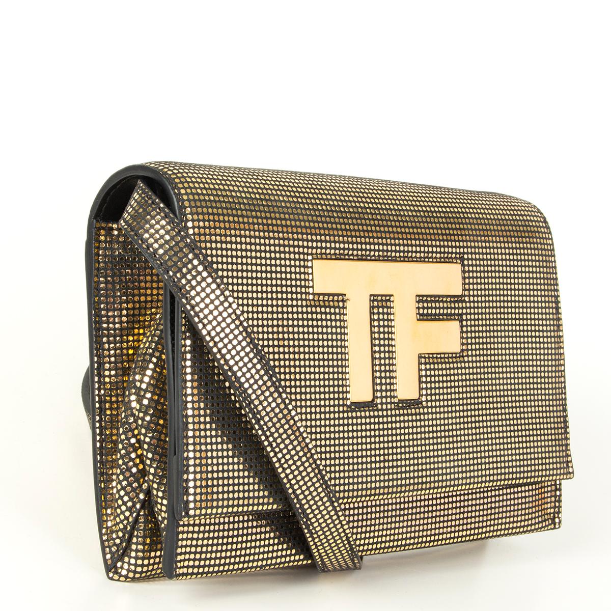 Tom Ford 'TF' logo corss-body/clutch bag in pinted gold-tone calfskin featuring a slit pocket on the back side. Opens with a flap and is lined in black calfskin and microfibre with two credit card slots, one open pocket and one zip pocket.