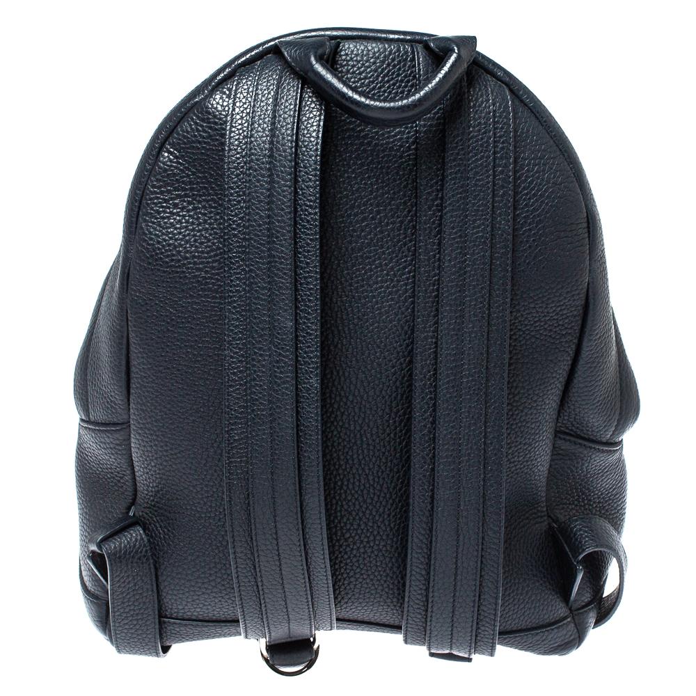 Tom Ford brings you a stylish and durable backpack ideal for daily commutes and travel escapades. Crafted from leather in a navy blue shade, the bag features a front pocket for easy organization. The zipper closure opens to a spacious canvas