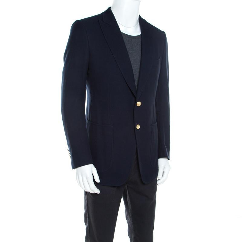 You're ready to be at any formal event in style with this smart navy blue jacket from Tom Ford. The creation is made of quality cotton, and it comes with waffle textures, peak lapels and front gold buttons.

