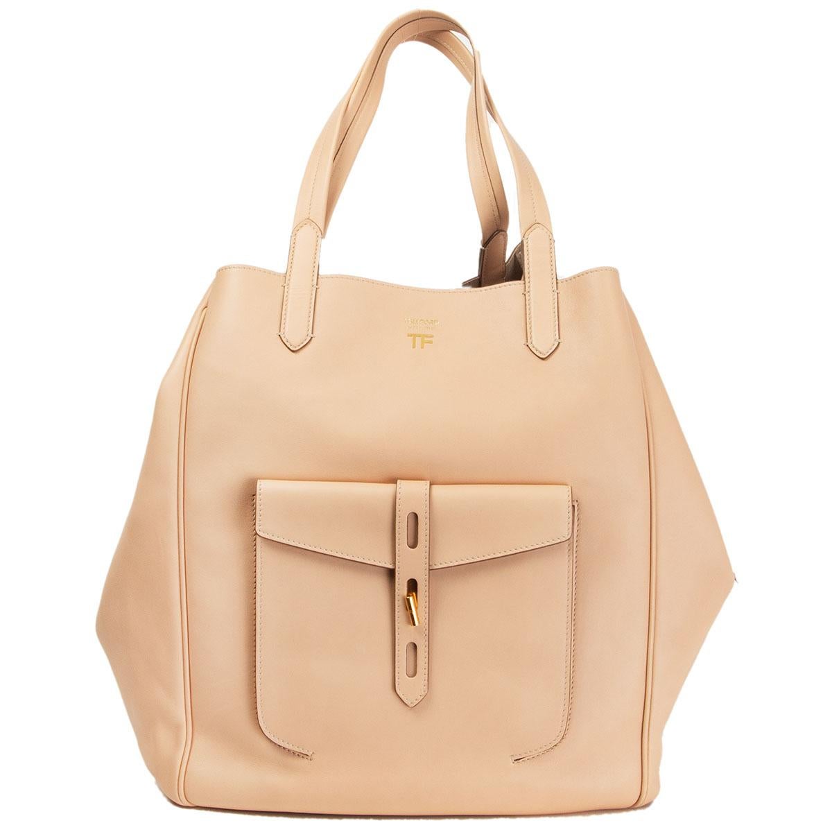 Tom Ford 'Hollywood Large Tote' bag in Oat (nude) soft smooth calf leather. Spring 2019 runway bag. Outside flap pocket. Closes with a strap and twist lock on top. Unlined with two open pockets and a zipper pocket against the back. Has been carried