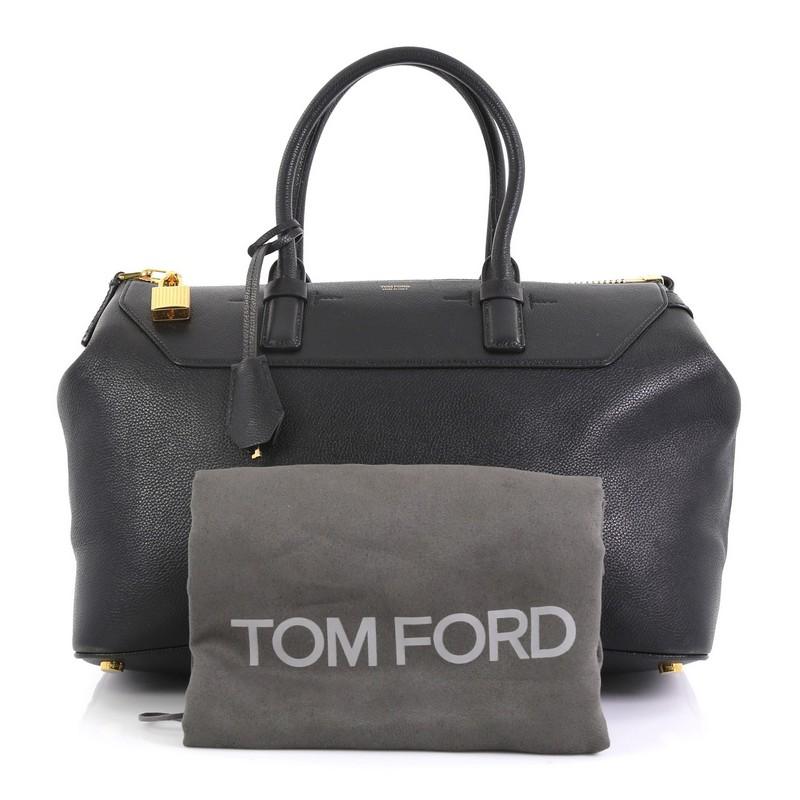This Tom Ford Petra Tote Calfskin Medium, crafted in black calfskin leather, features tall dual-rolled handles,Tom Ford gold stamped logo, lock accents and gold-tone hardware. Its top zip closure opens to a matching black microfiber interior with