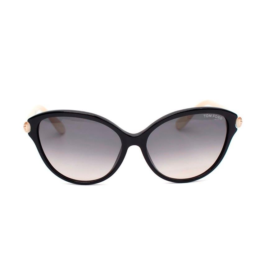  Tom Ford Priscilla Black & Cream Cat-Eye Sunglasses

- Grey gradient lenses
- The ivory coloured paddle arms and gold toned 'T' branding overlapping the hinges 
- Black single bridge full rim frame

Materials:
Plastic

Made in Italy

PLEASE NOTE,