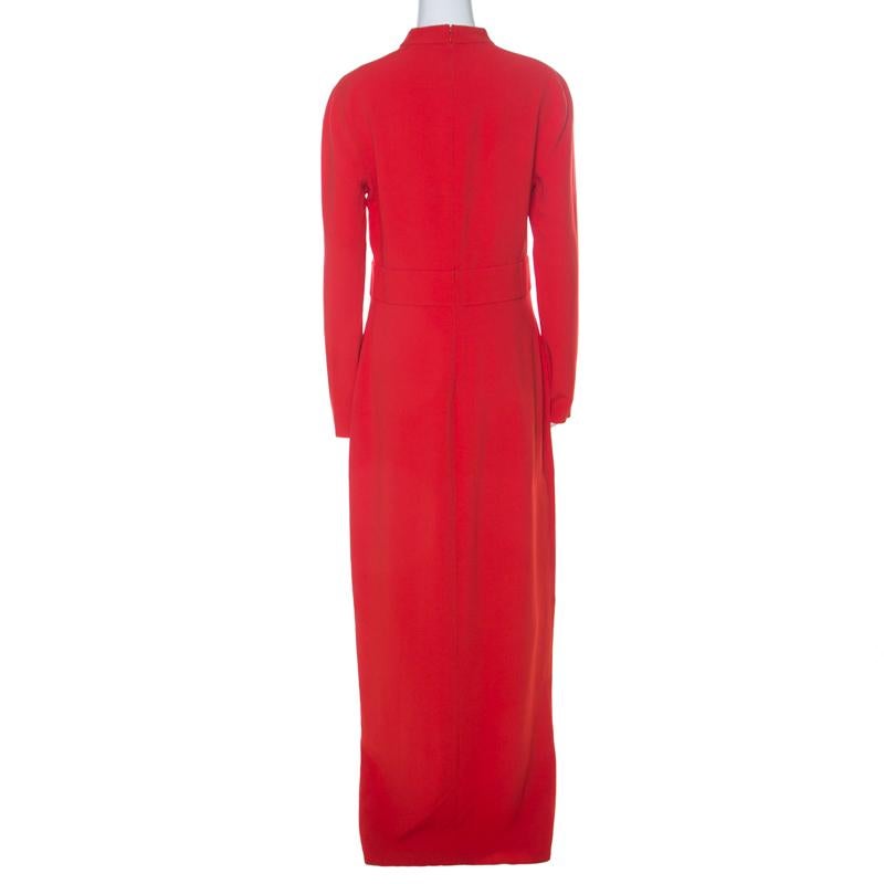 A gown in scarlet red to light up glitzy evening parties and help you make a style statement is this one from Tom Ford. It comes with long sleeves, a slit at the front and a cutout at the chest area. The gown will be perfect with gold accessories.

