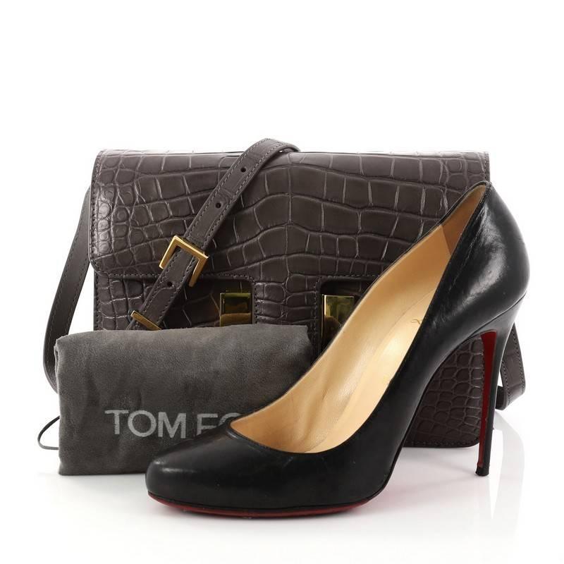 This authentic Tom Ford Sienna Shoulder Bag Alligator Medium is a perfectly crafted bag ideal for on the go moments. Crafted in genuine taupe alligator, this bag features adjustable leather shoulder strap, push lock-fastening front flap and