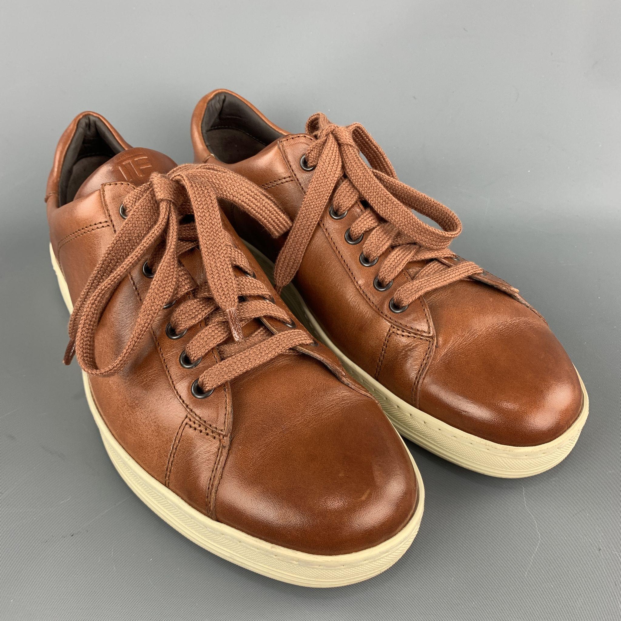 TOM FORD sneakers comes in a tan leather featuring a lace up style and a rubber sole. Made in Italy.

Excellent Pre-Owned Condition.
Marked: 11

Outsole: 4 in. x 12 in. 
