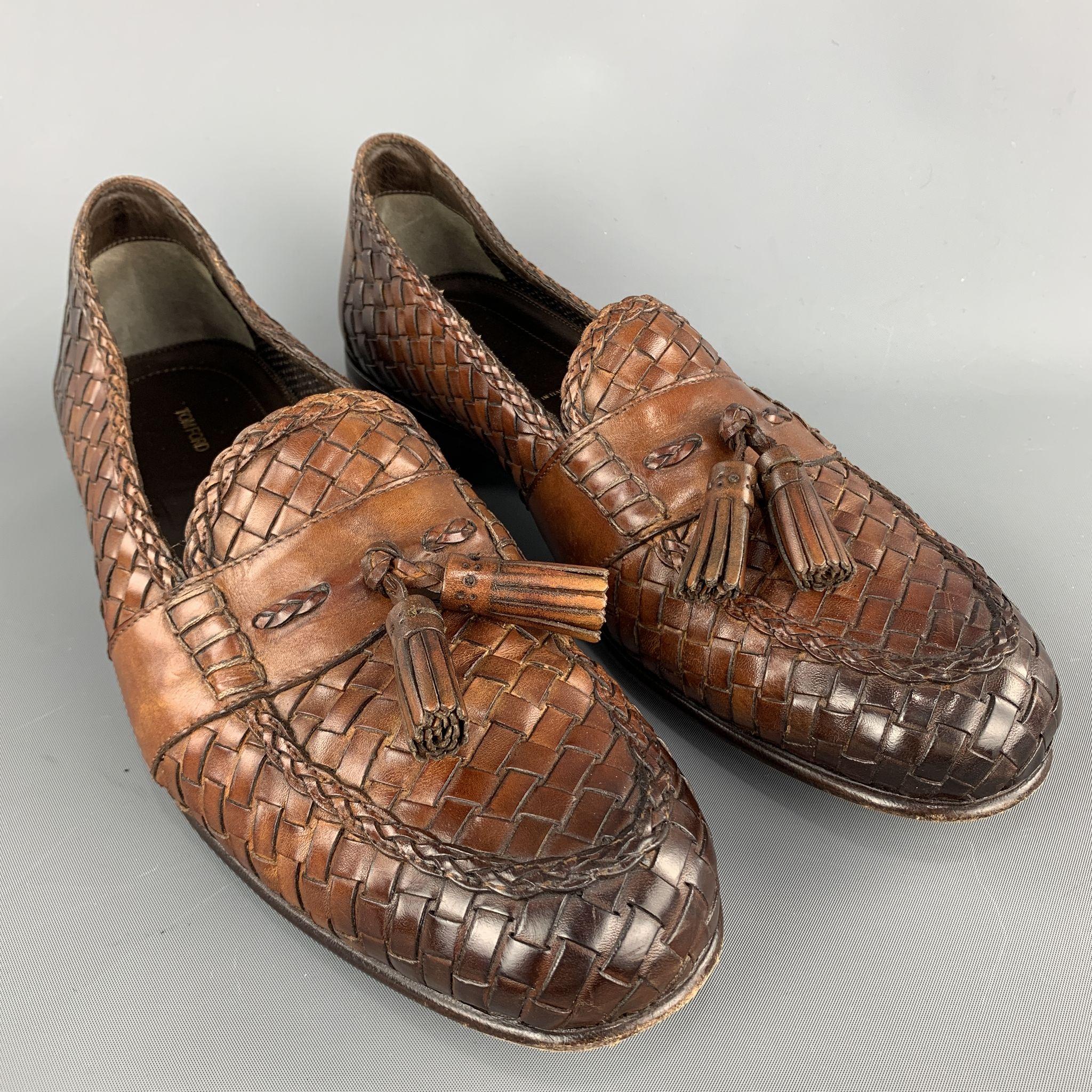 TOM FORD loafers comes in tan woven leather featuring a slip on style, front tassel details, and a wooden heel. Made in Italy.

Excellent Pre-Owned Condition.
Marked: 11 T

Outsole: 4 in. x 12 in. 