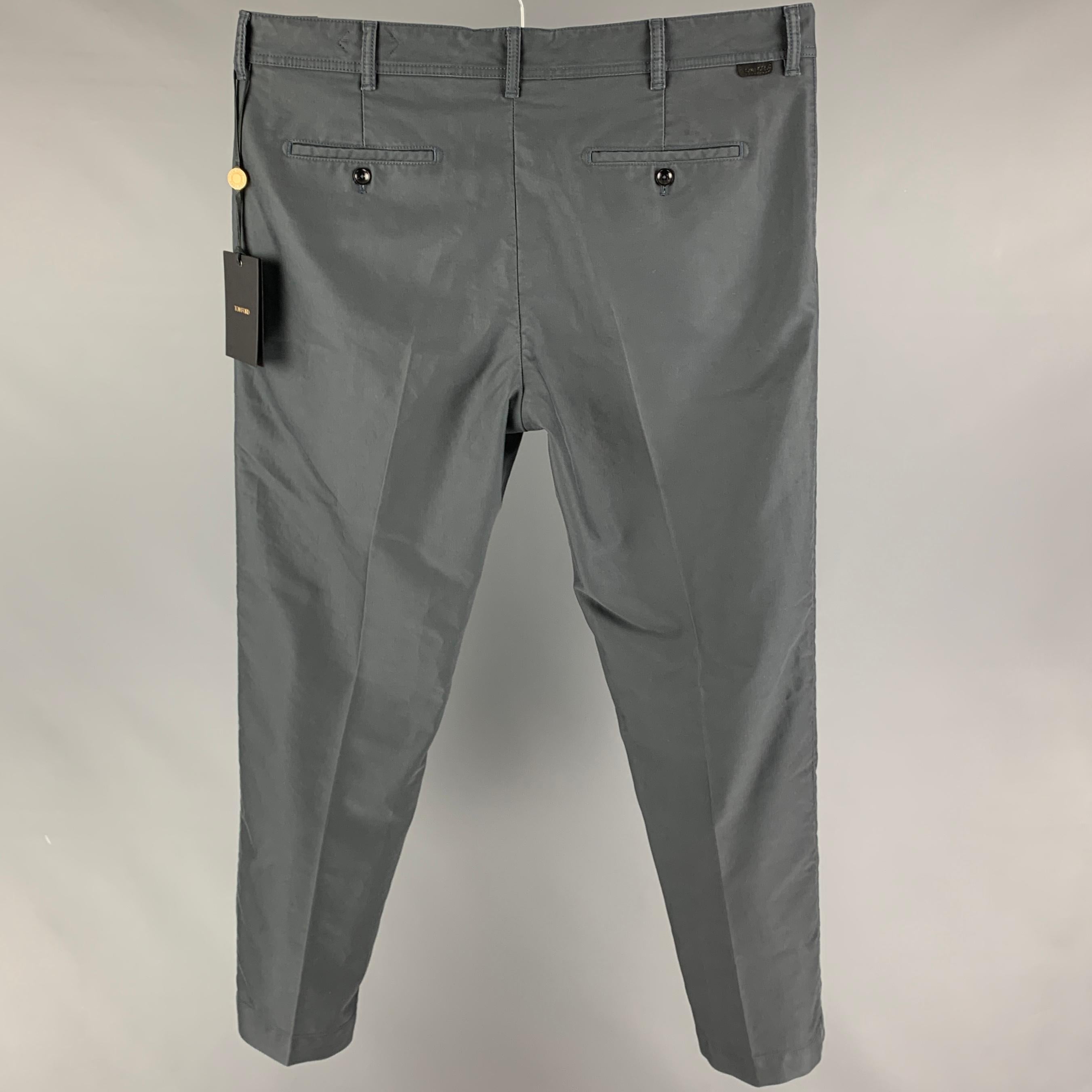 TOM FORD casual pants comes in a slate cotton featuring a flat front, front tab, and a button fly closure. Made in Italy. 

New With Tags. 
Marked: 38
Original Retail Price: $790.00

Measurements:

Waist: 40 in.
Rise: 11.5 in.
Inseam: 31 in. 