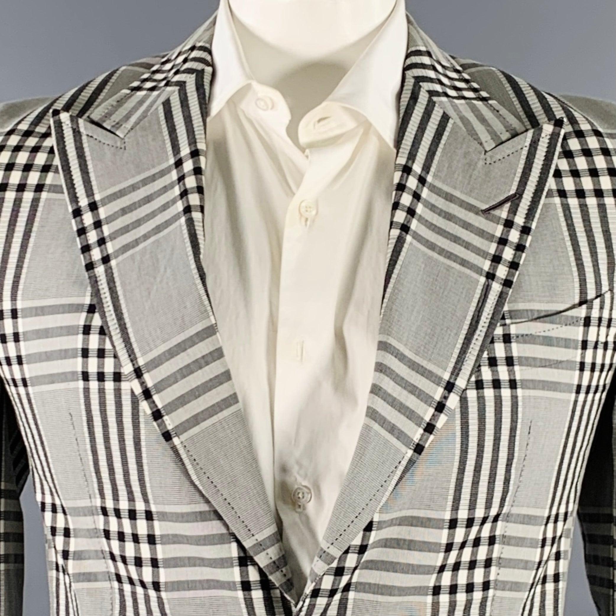 TOM FORD sport coat
in a
grey and black cotton woven fabric featuring a plaid pattern, peak lapel, single vented back, and double button closure. Note: this garment has been professionally altered. Please double check measurements.Excellent