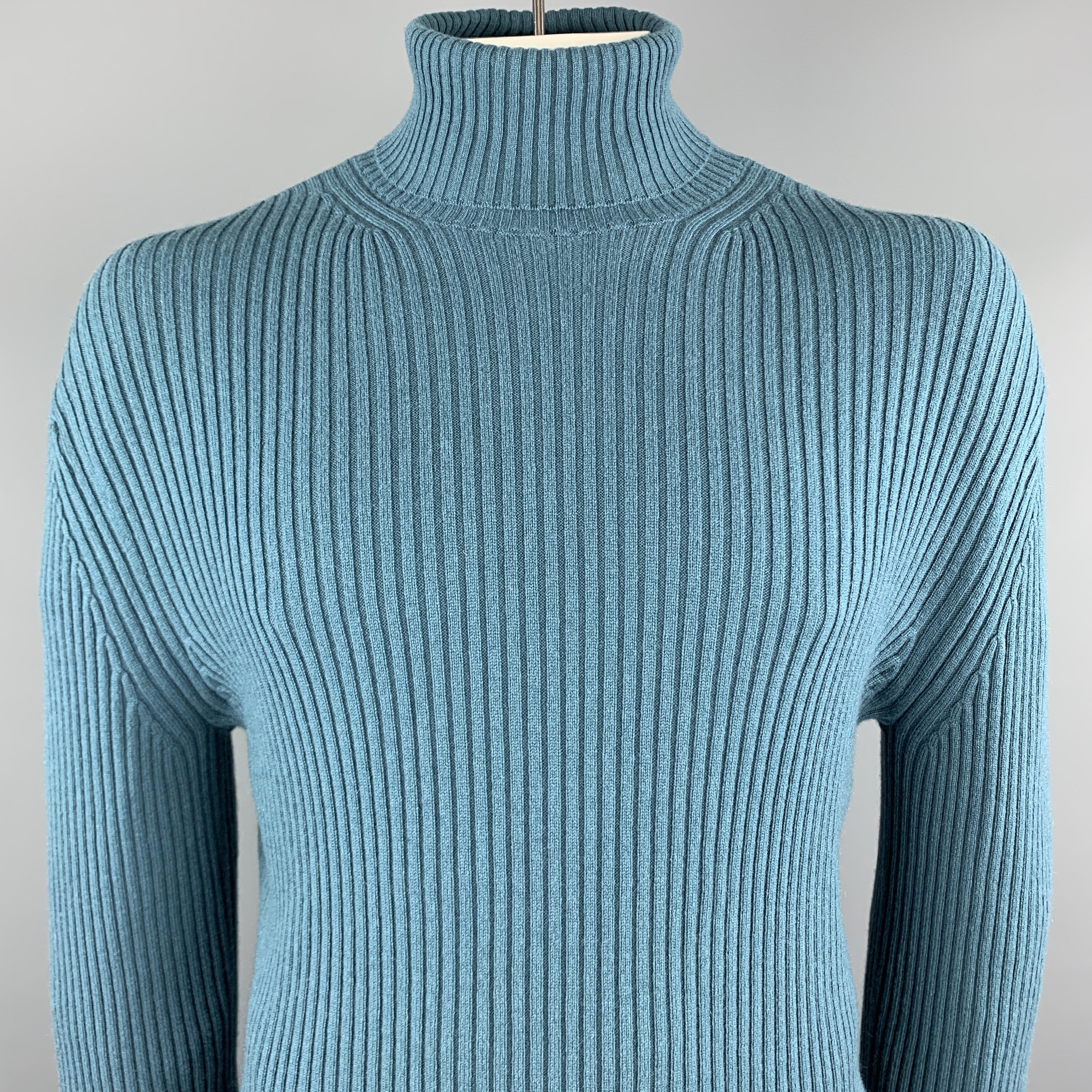 TOM FORD sweater comes in a teal ribbed knit cashmere featuring a turtleneck style. Made in Italy.

Excellent Pre-Owned Condition.
Marked: IT 54

Measurements:

Shoulder: 22 in. 
Chest: 44 in. 
Sleeve: 28.5 in. 
Length: 27 in.