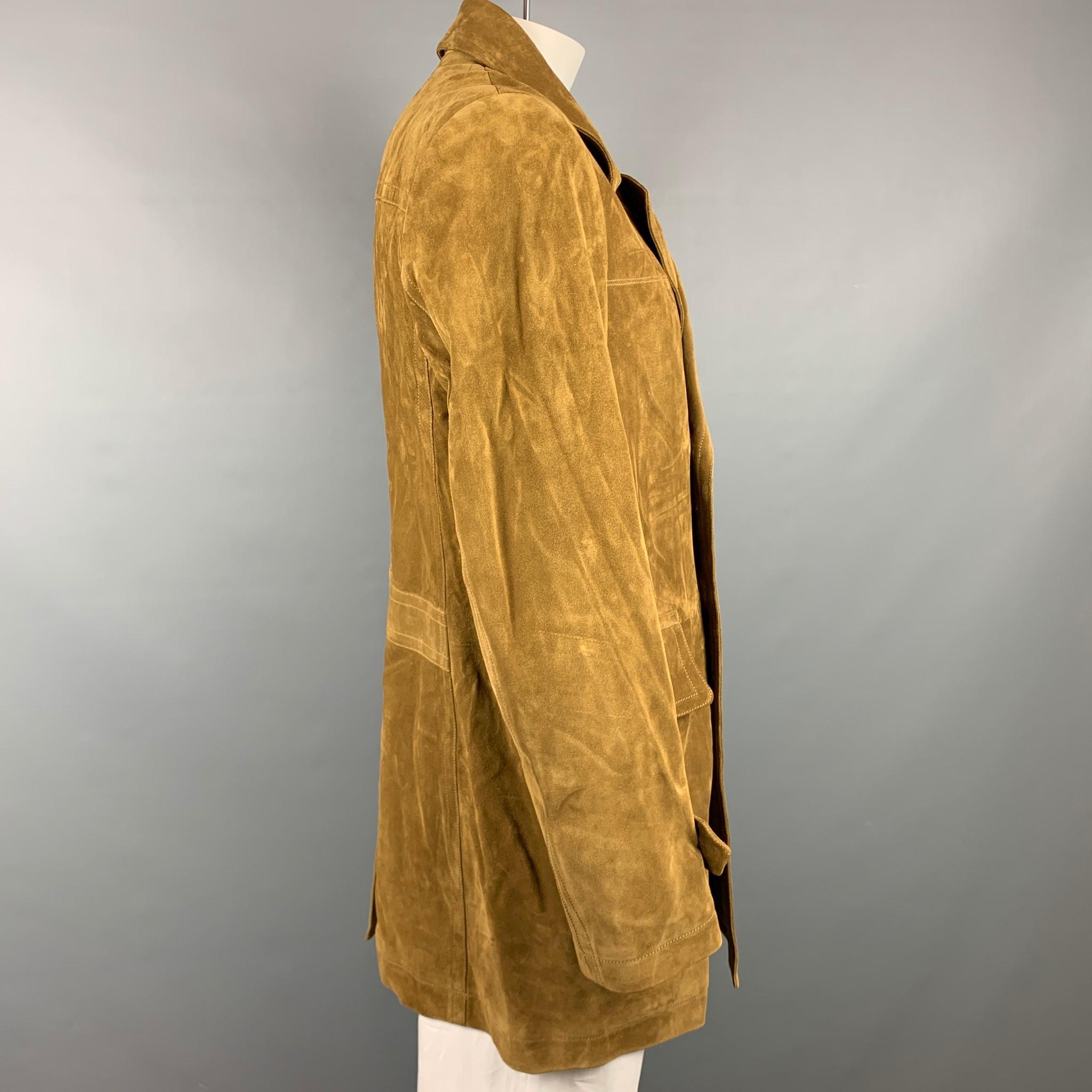 TOM FORD coat comes in a tan textured suede with a full liner featuring flap pockets, contrast stitching, notch lapel, and a double breasted closure. Made in Italy.

Very Good Pre-Owned Condition.
Marked: IT 58
Original Retail Price: