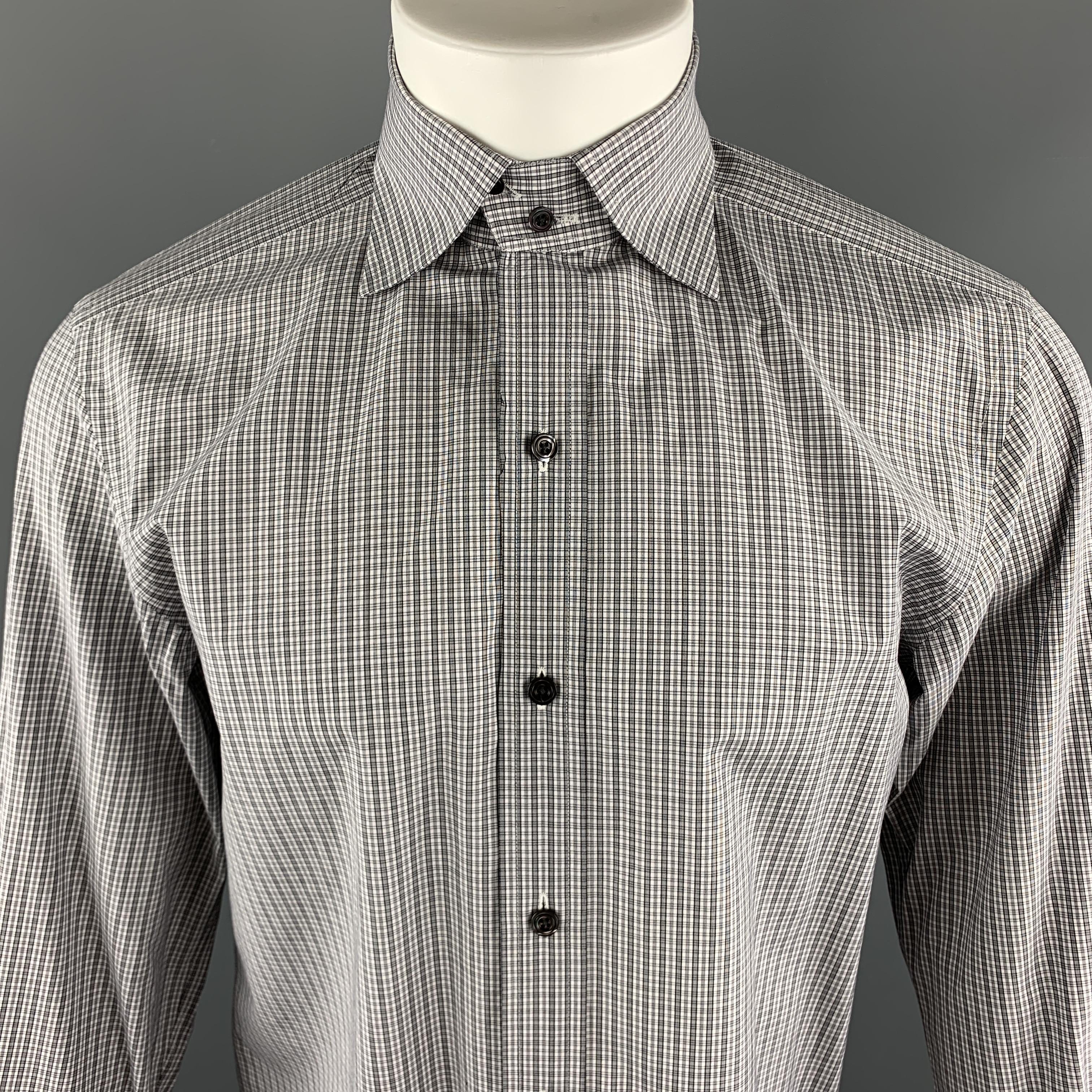 TOM FORD Long Sleeve Shirt comes in a grey plaid cotton material, with a double buttoned spread collar, French cuffs, button up. Made in Switzerland. 

Excellent Pre-Owned Condition.
Marked: 40   15 3/4

Measurements:

Shoulder: 17.5 in.
Chest: 42