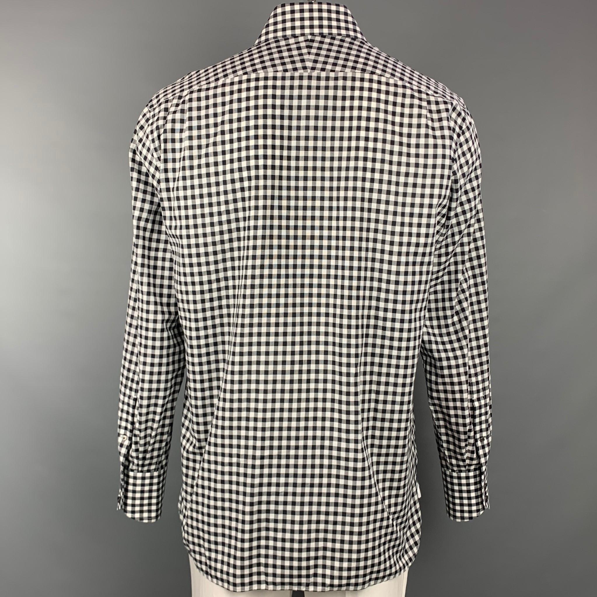 TOM FORD long sleeve shirt comes in a black & white checkered cotton featuring a button up style and a spread collar. Made in Italy.

Very Good Pre-Owned Condition.
Marked: 43/17

Measurements:

Shoulder: 19.5 in.
Chest: 46 in.
Sleeve: 27
