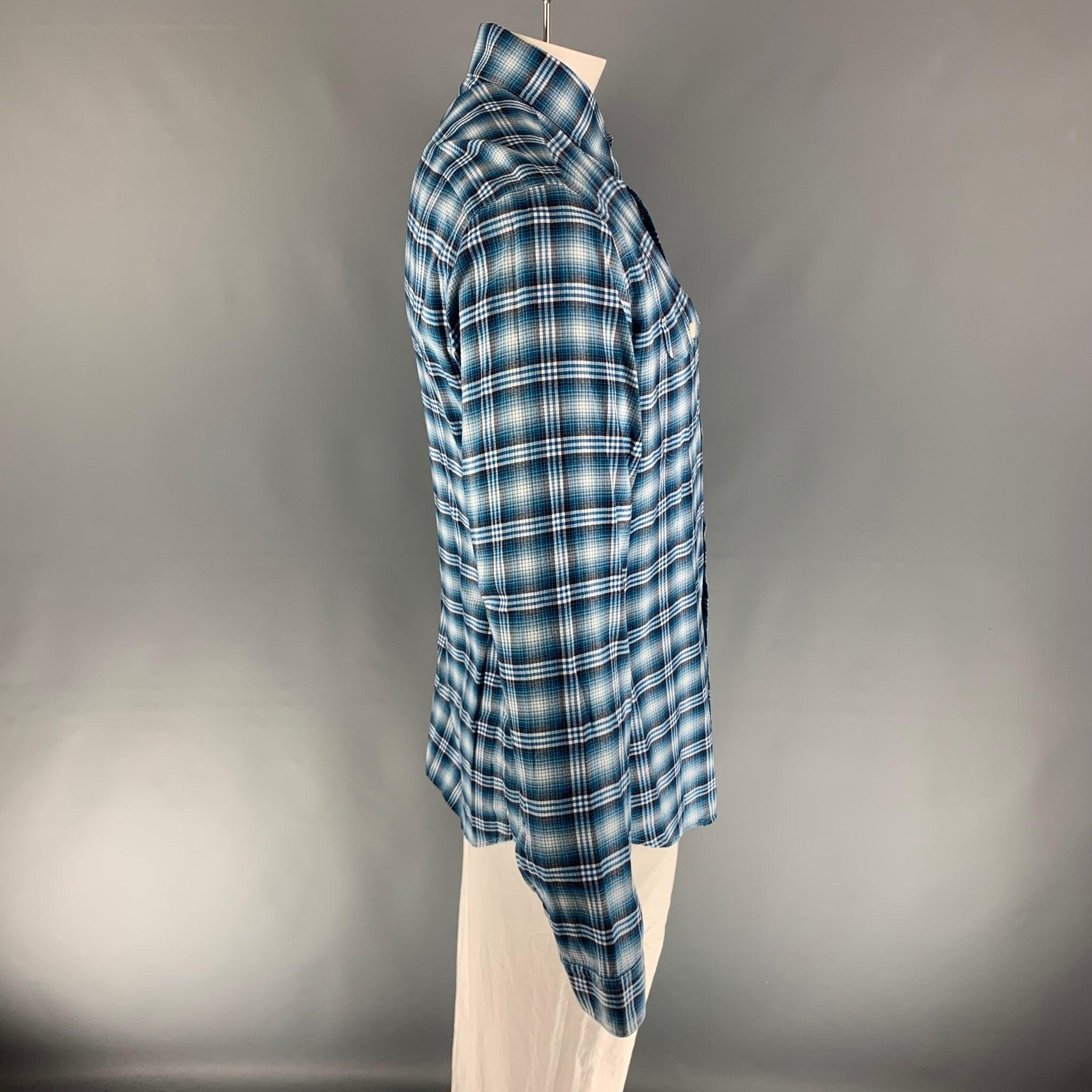 TOM FORD long sleeve button down flannel comes in a turquoise & white plaid pattern with two front patch pockets, as well as a spread collar. 100% cotton.
Very Good Pre-Owned Condition. 

Marked:   44 & 17 1/2
 

Measurements: 
  
Shoulder: 19.5