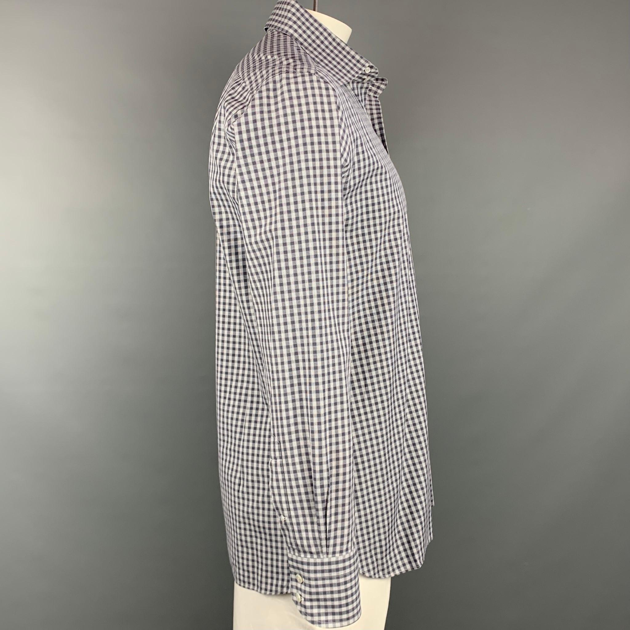 TOM FORD long sleeve shirt comes in a grey & white plaid cotton featuring a button up style and a spread collar. Made in Italy.

Very Good Pre-Owned Condition.
Marked: 44/ 17.5

Measurements:

Shoulder: 19.5 in.
Chest: 46 in.
Sleeve: 27 in.
Length: