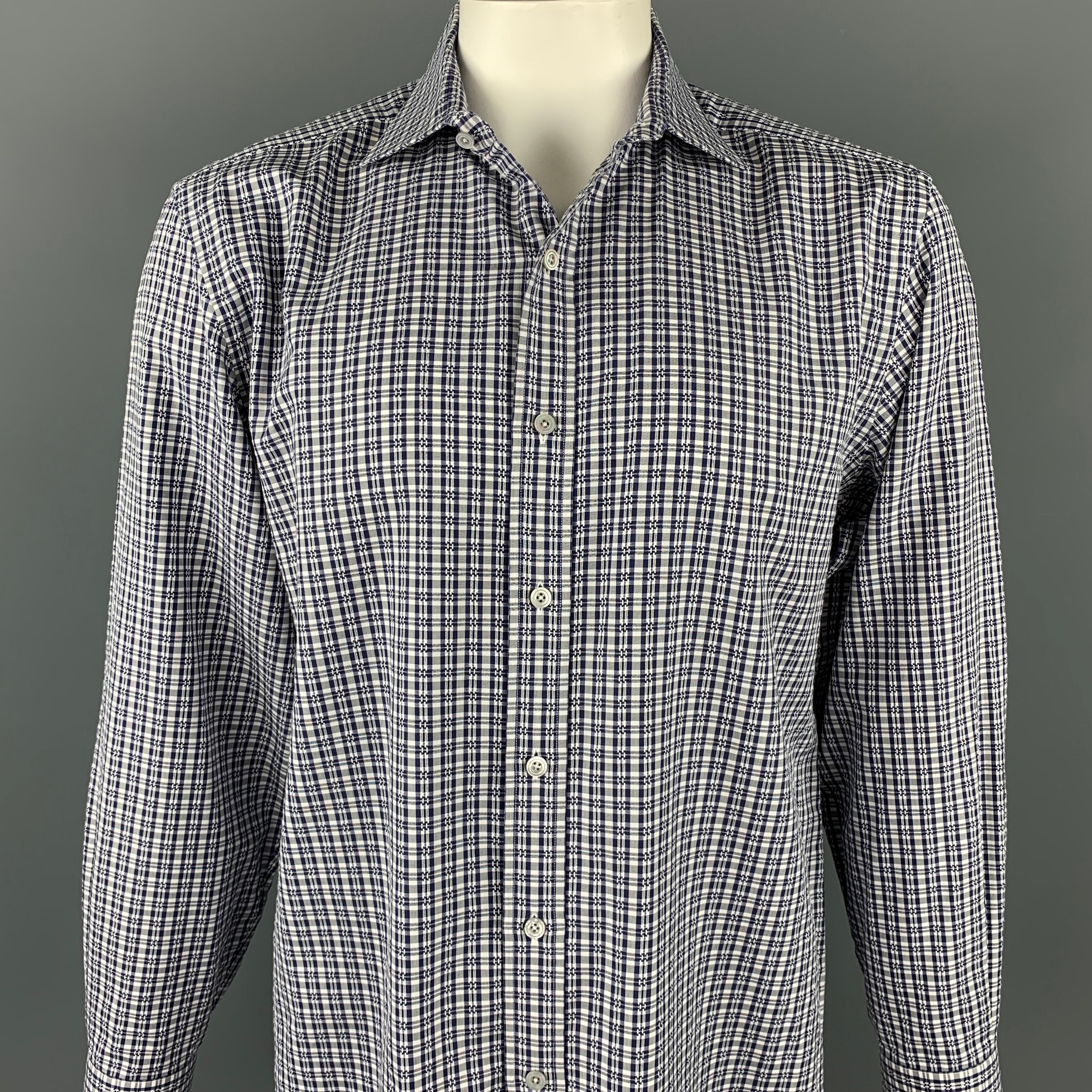 TOM FORD long sleeve shirt comes in a navy & white plaid cotton featuring a button up style and a spread collar. Made in Italy.

Very Good Pre-Owned Condition.
Marked: 44/17.5

Measurements:

Shoulder: 19.5 in.
Chest: 48 in.
Sleeve: 27 in.
Length: